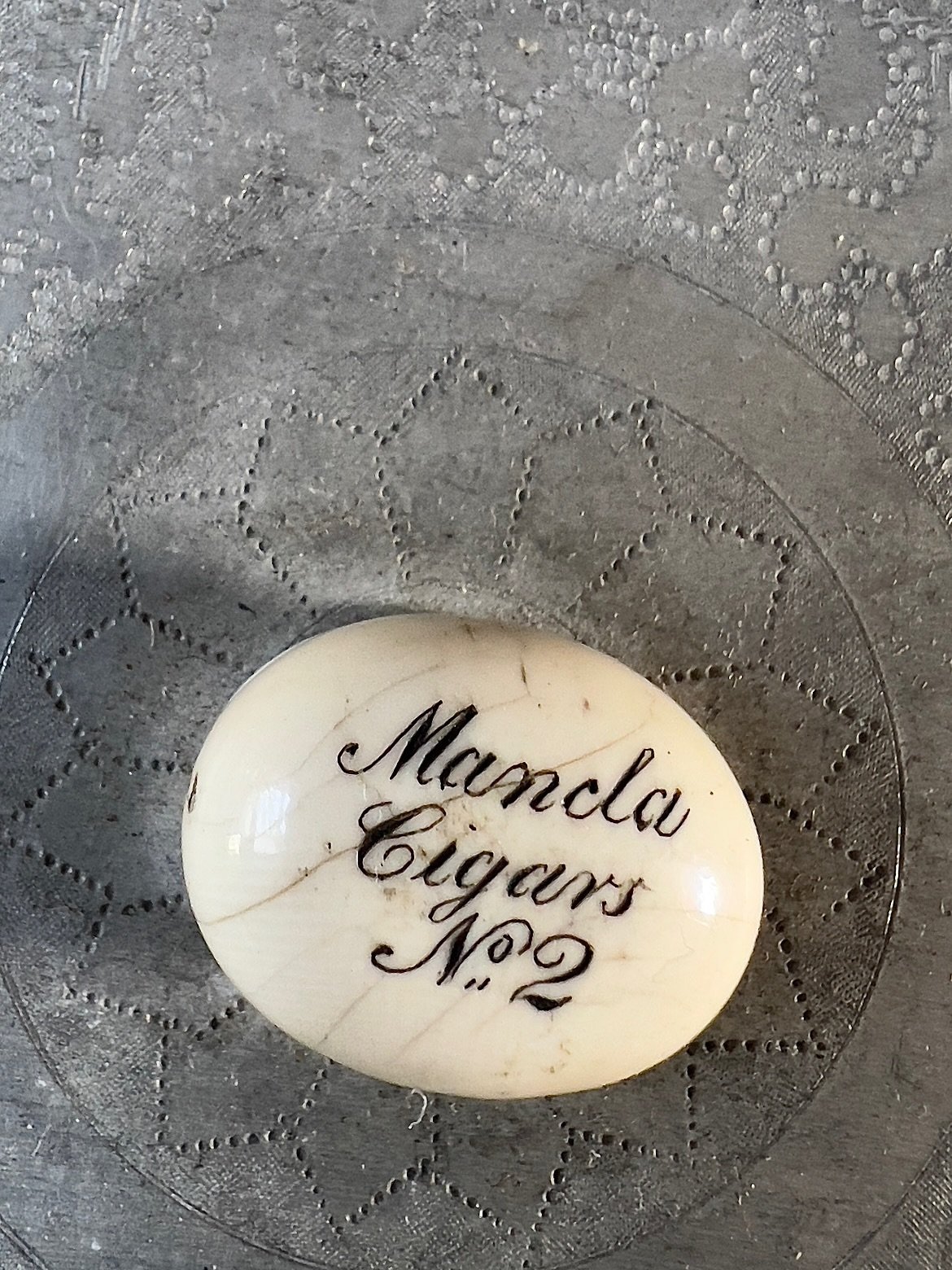 These really appealed to us.  Beautifully hand-crafted metal cigar storage boxes with a finely etched detail on each lid. Each one unique with its own carved  button handle inscribed with the  name of its original contents.  Scroll to the end to see 