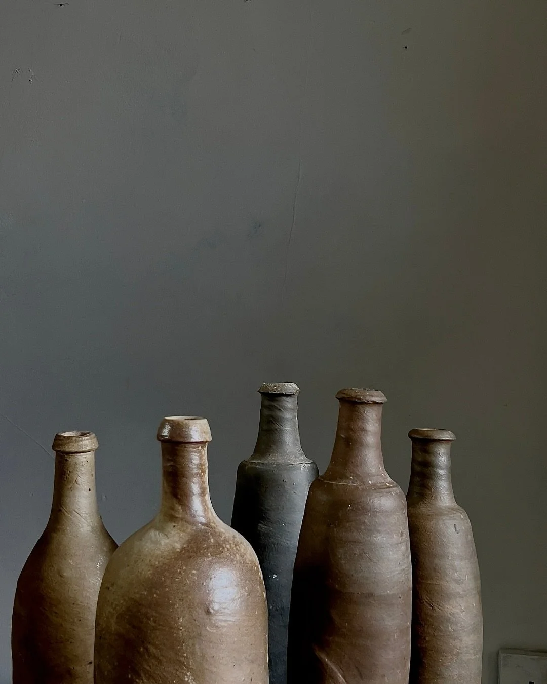 Handmade 19th-century Normandy stoneware Calvados bottles are prized for their simple form, rich darkened tones, each one unique; their striking presence, brings both history and style to any space. Whether you prefer minimal or a busy and eclectic i
