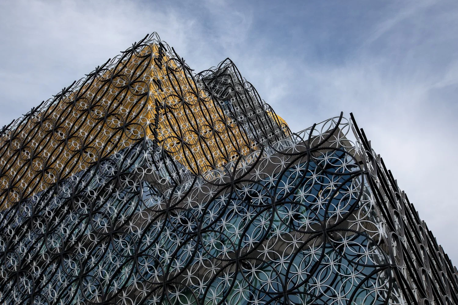 Colour photograph of the Library of Birmingham, highlighting its modern architecture and decorative metal façade in natural light.