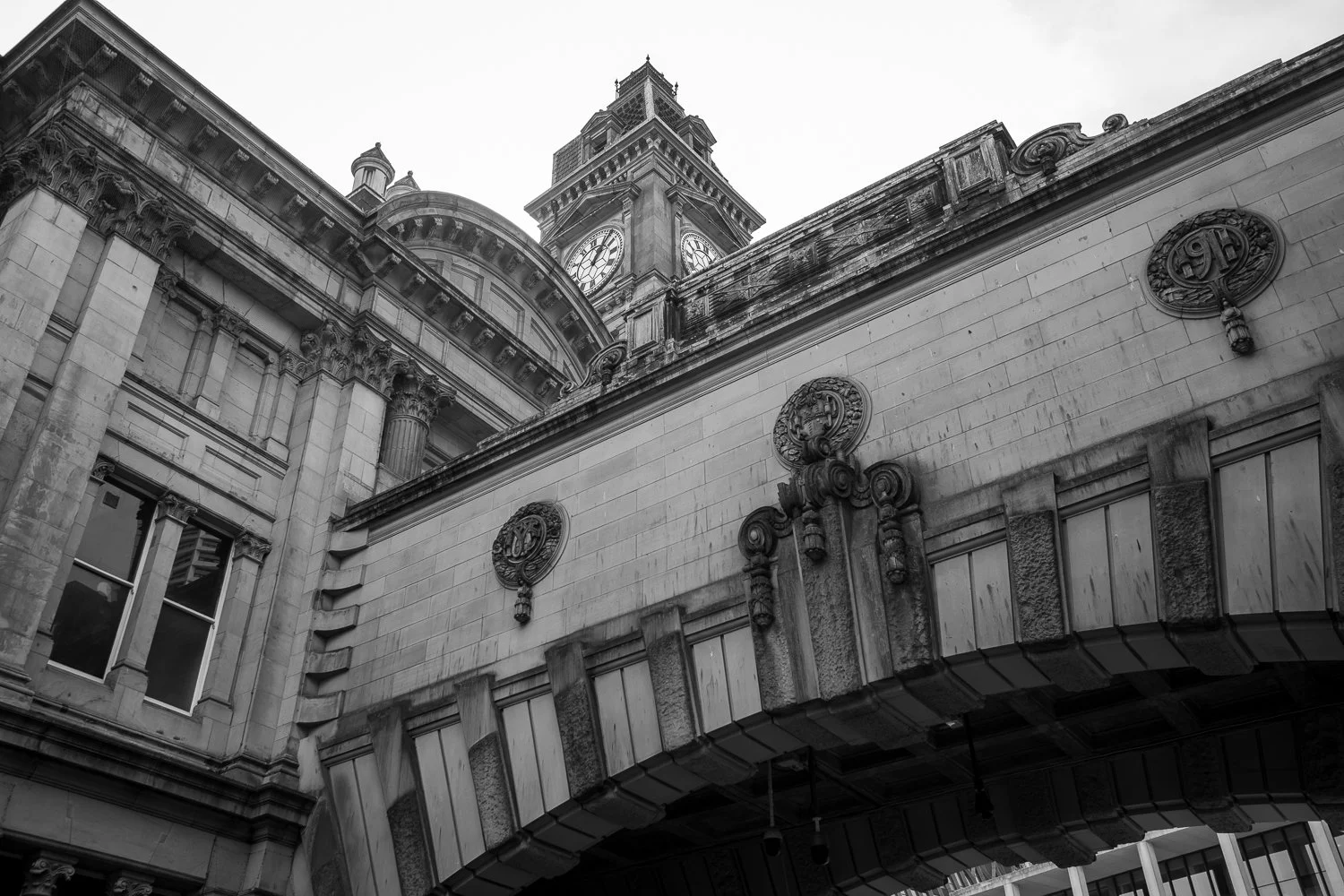 Black and white photograph of Birmingham Museum & Art Gallery taken from Chamberlain Square, showing classical architecture and stone columns. (Copy)