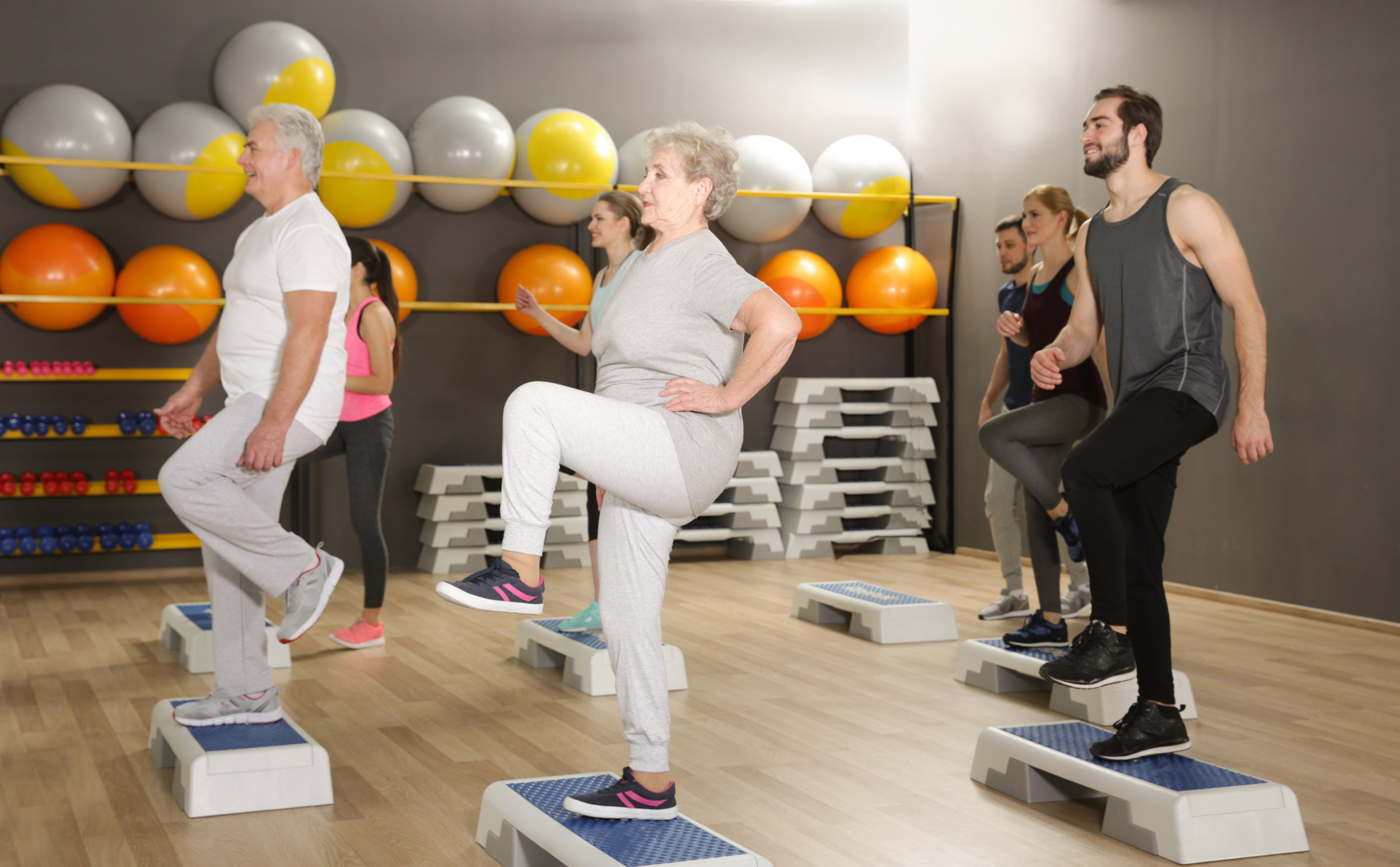 People of different ages training in gym