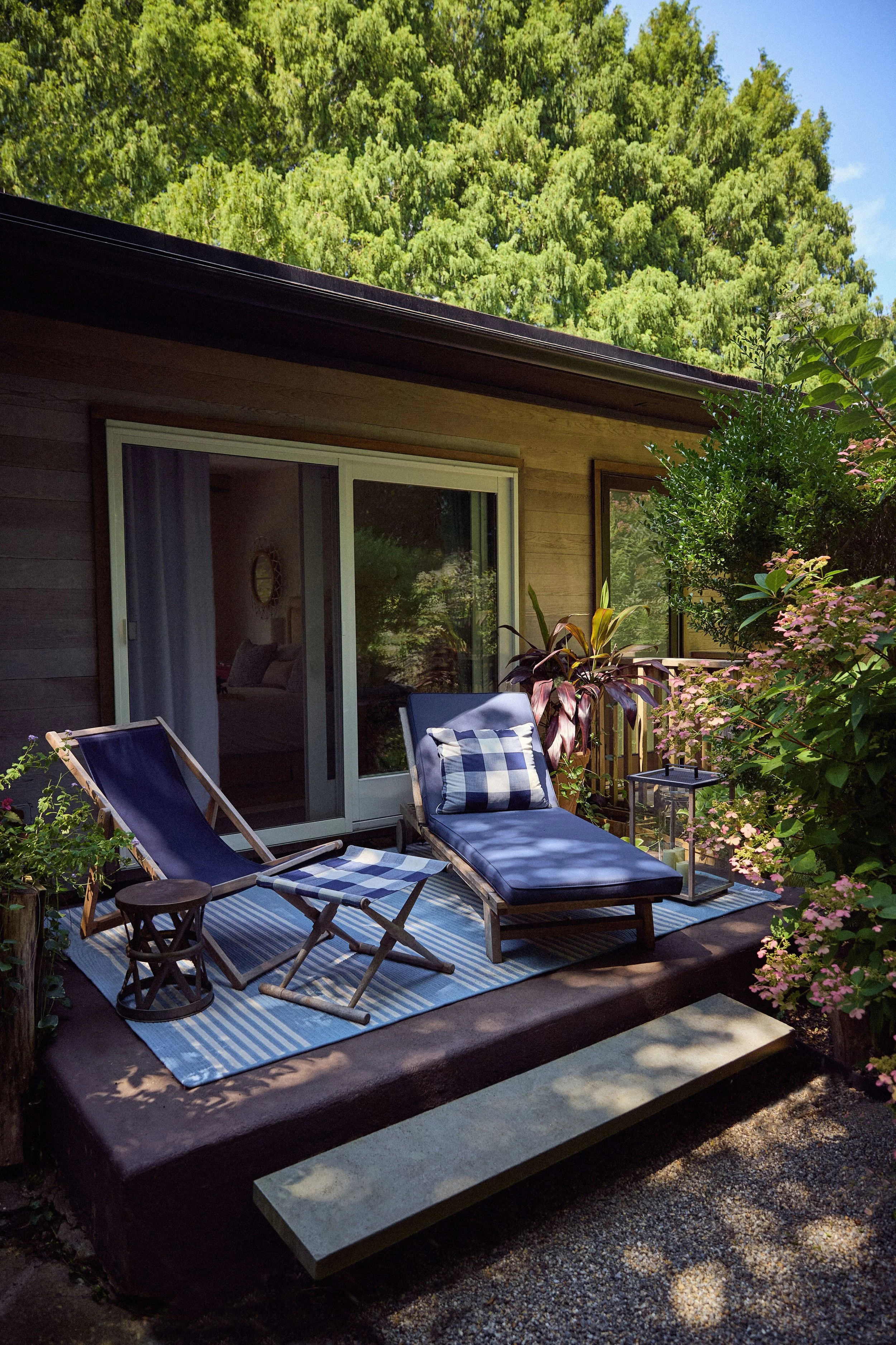 Private patio with lounge chairs and garden views