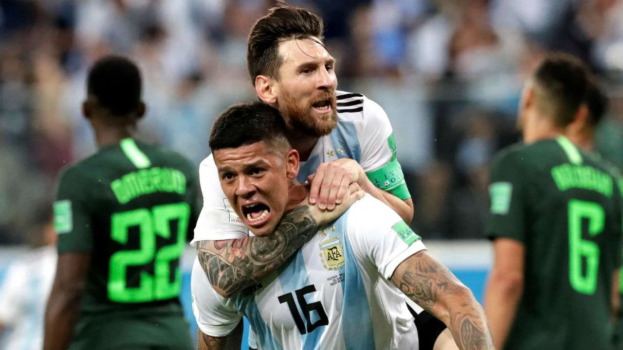 Marcos Rojo celebrates his game winning goal with captain Lionel Messi.