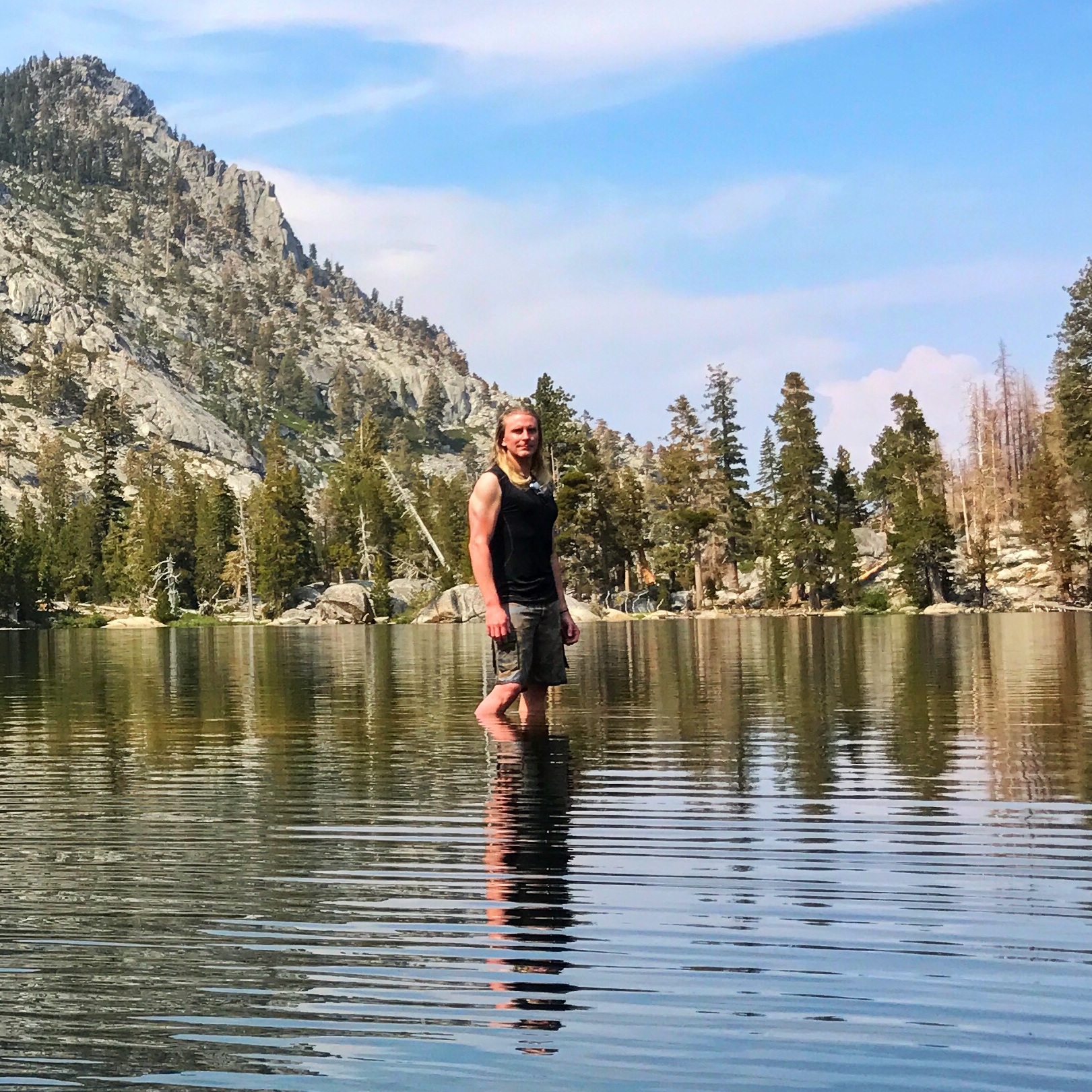 standing on a rock in the middle of the lake