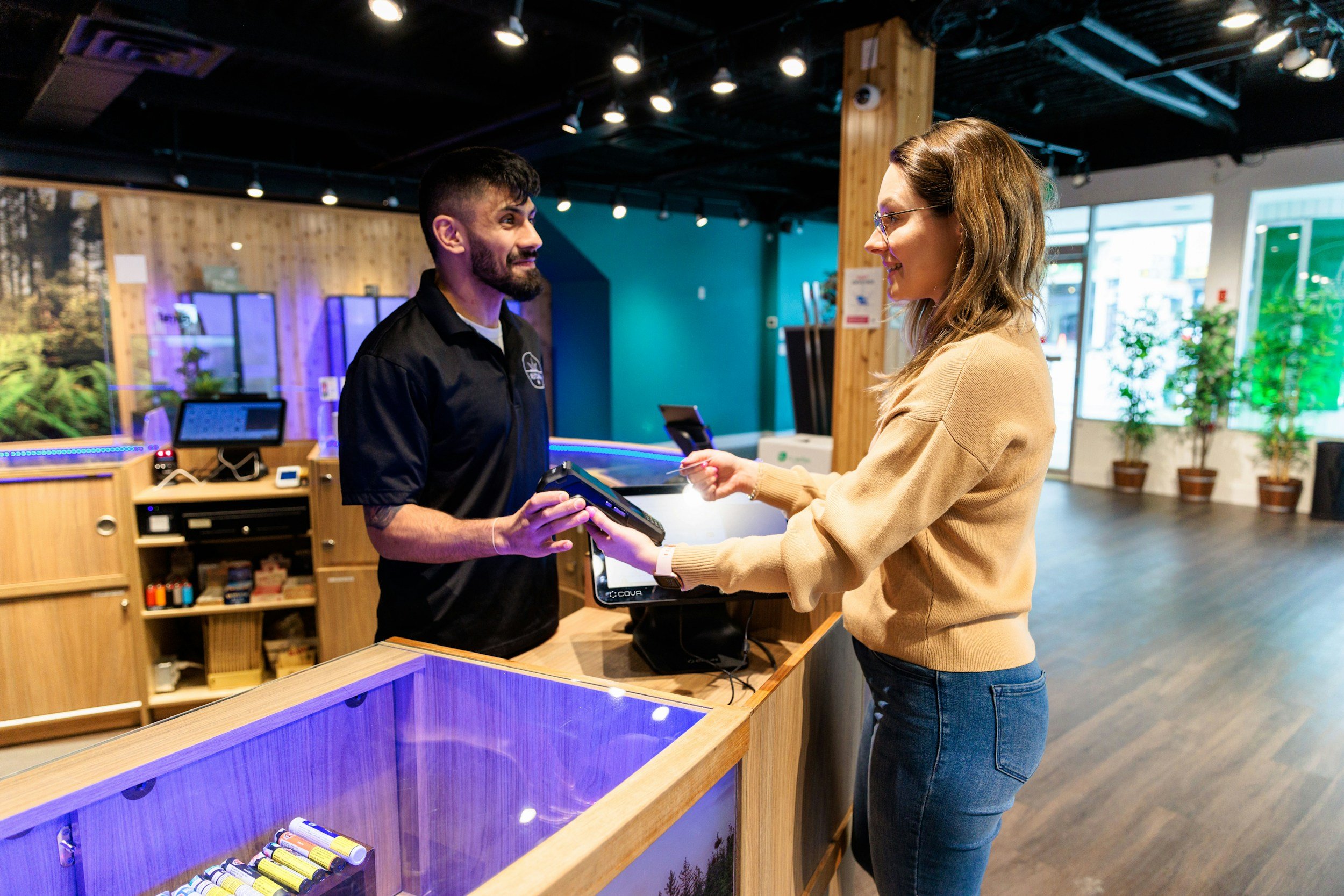 A budtender helps a customer make a choice on the dispensary menu.