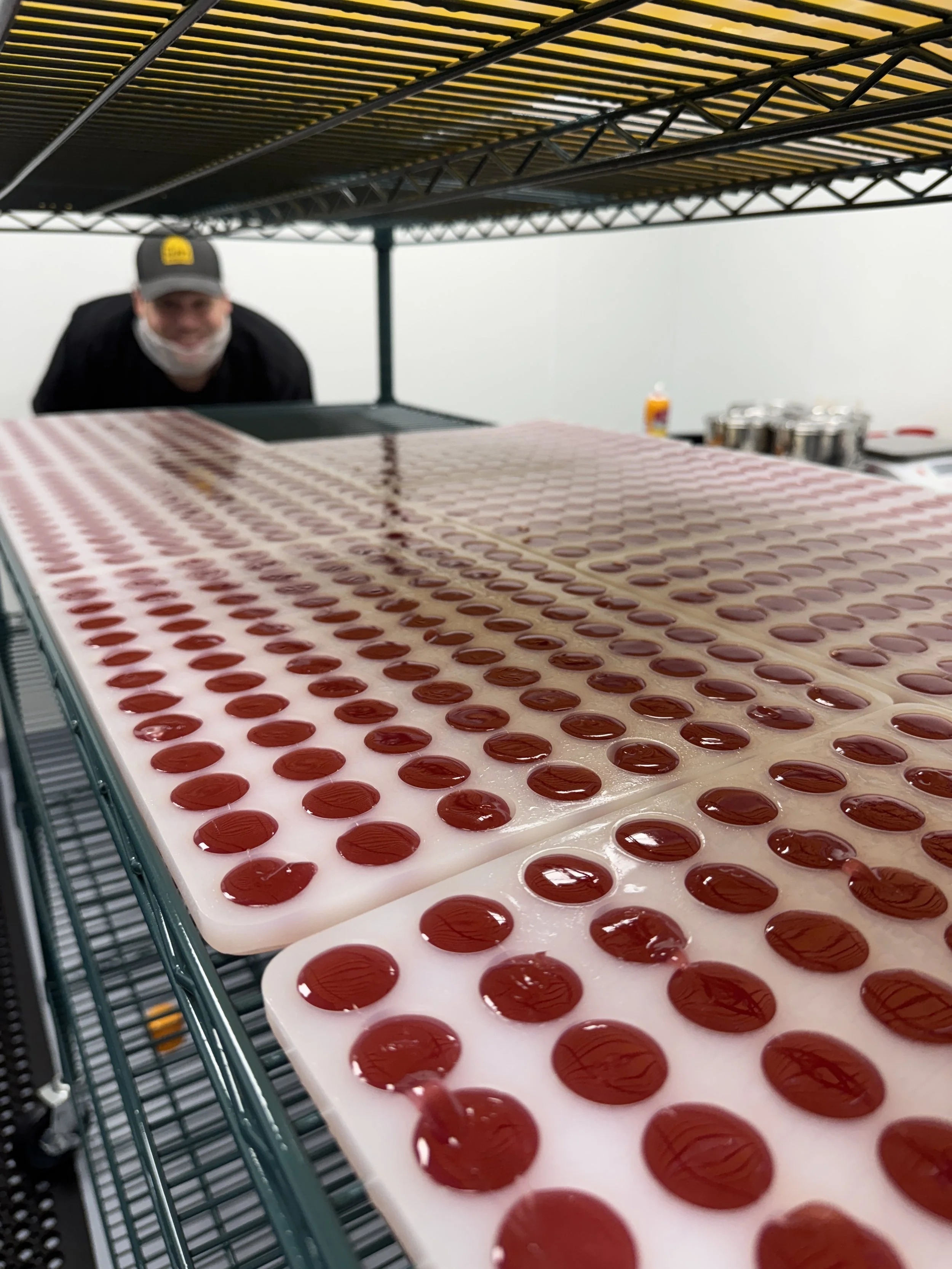 Boosted Berry Gems in their trays with Steven in the background.