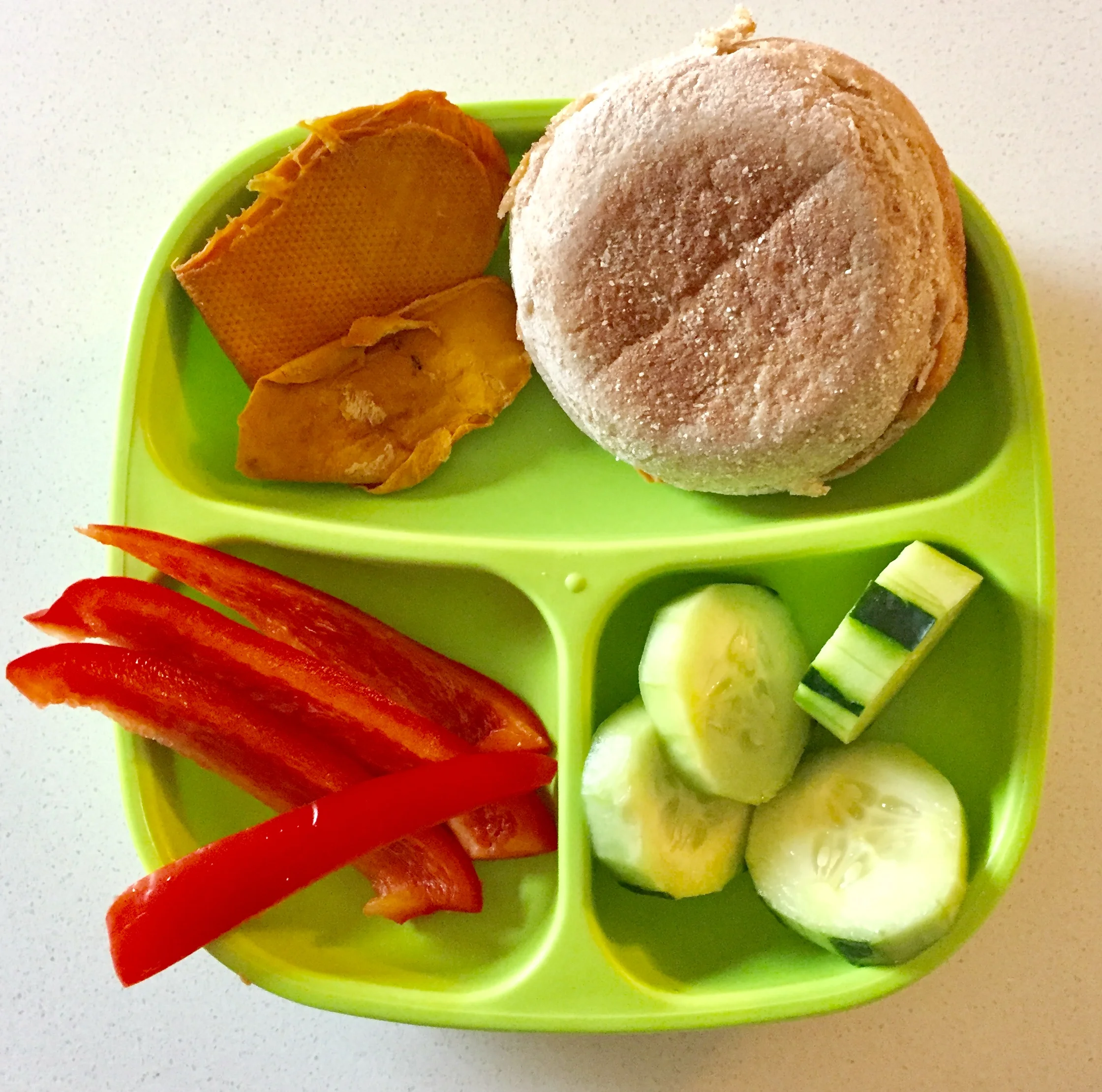 Peanut butter and honey sandwich in a whole wheat english muffin, cucumbers, red bell peppers, and dry mango for dessert.