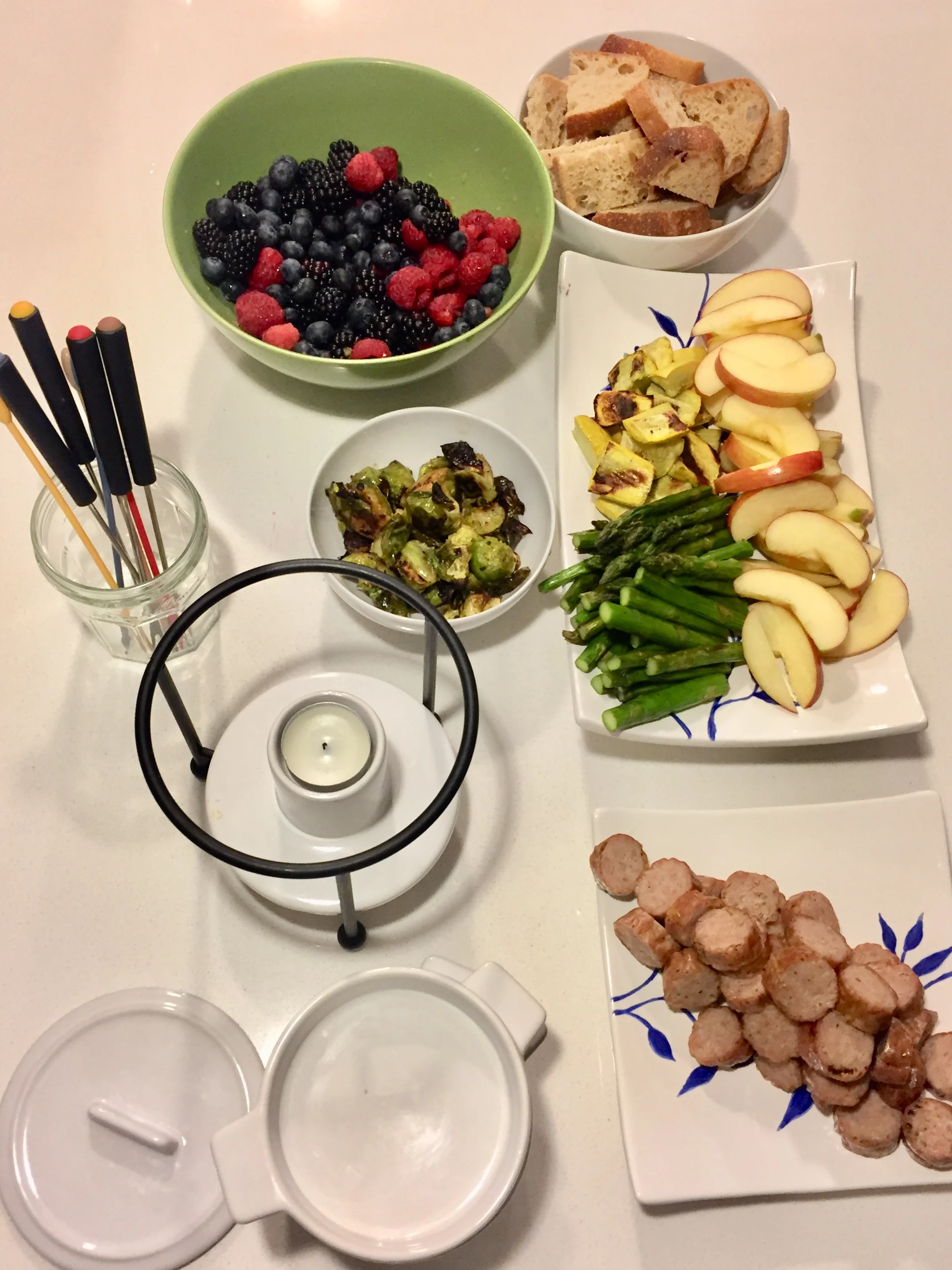 Fondue: Berries, whole wheat bread, apples. Asparagus, brussels sprouts, yellow zucchini, and sausages (on the grill) and of course cheese fondue (not in the picture).