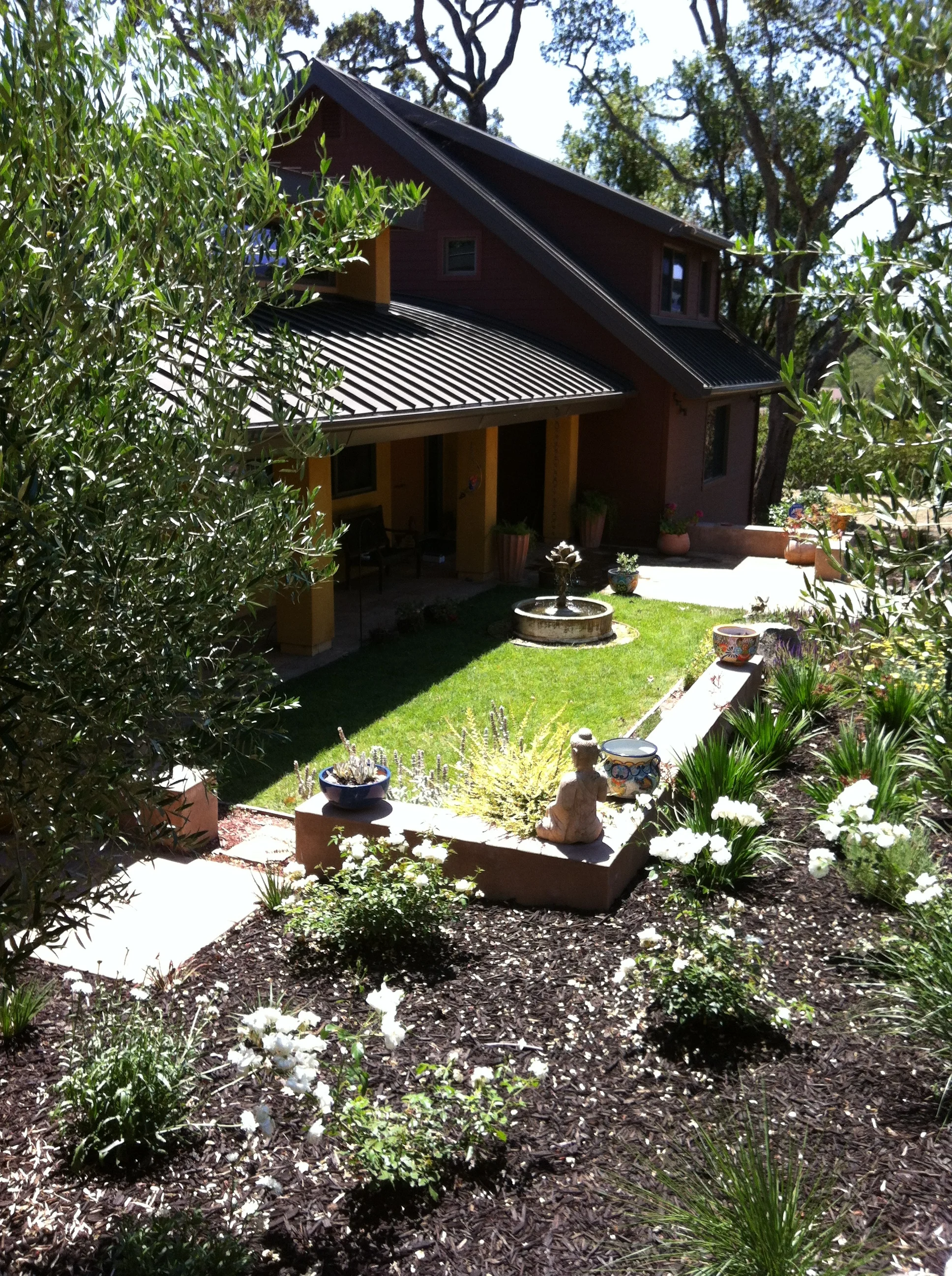  New exterior materials, forms, and colors were used to integrate a modernist addition with an existing two-story conventional house. 