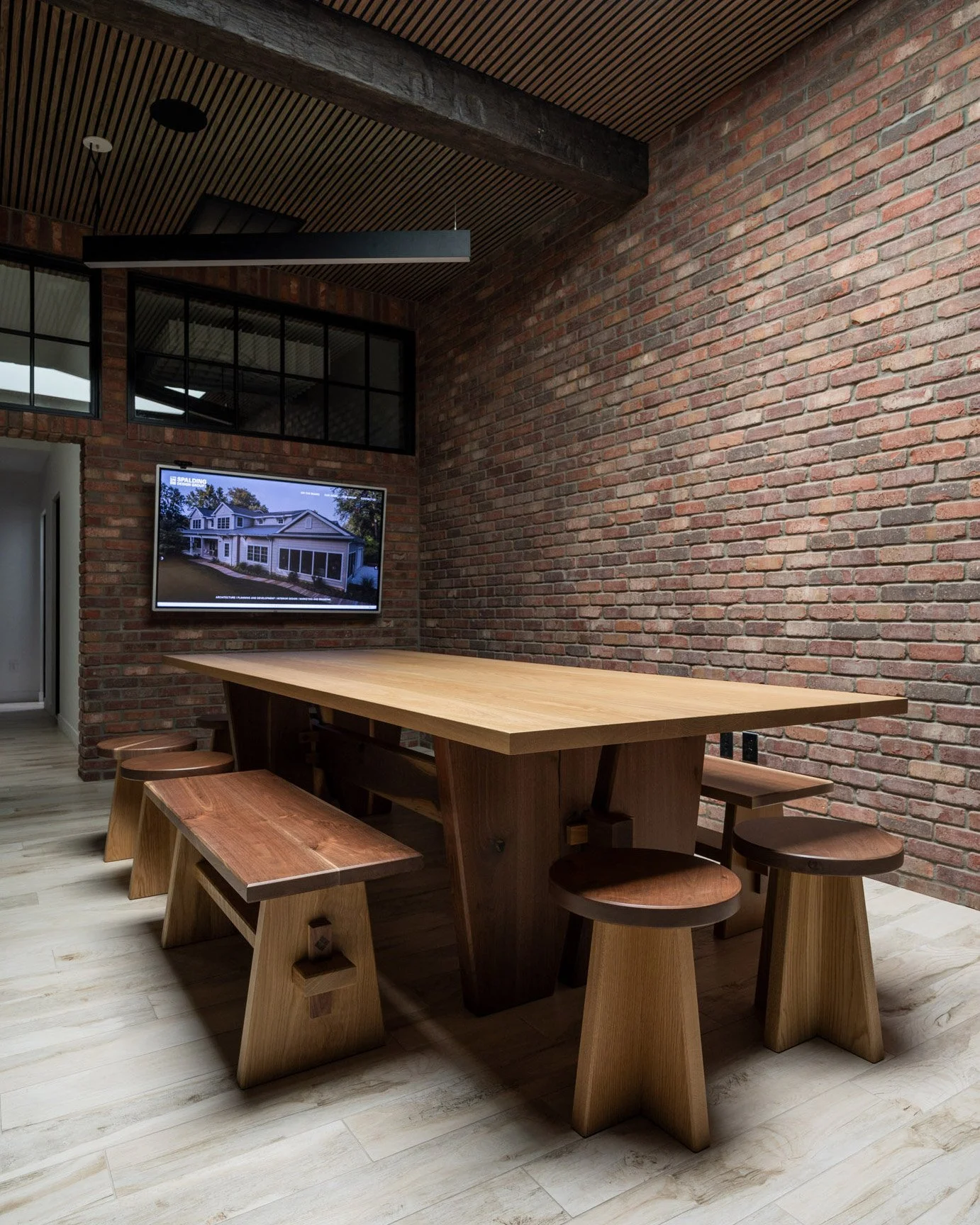 Hand crafted conference table and stool set in an architecture firm.