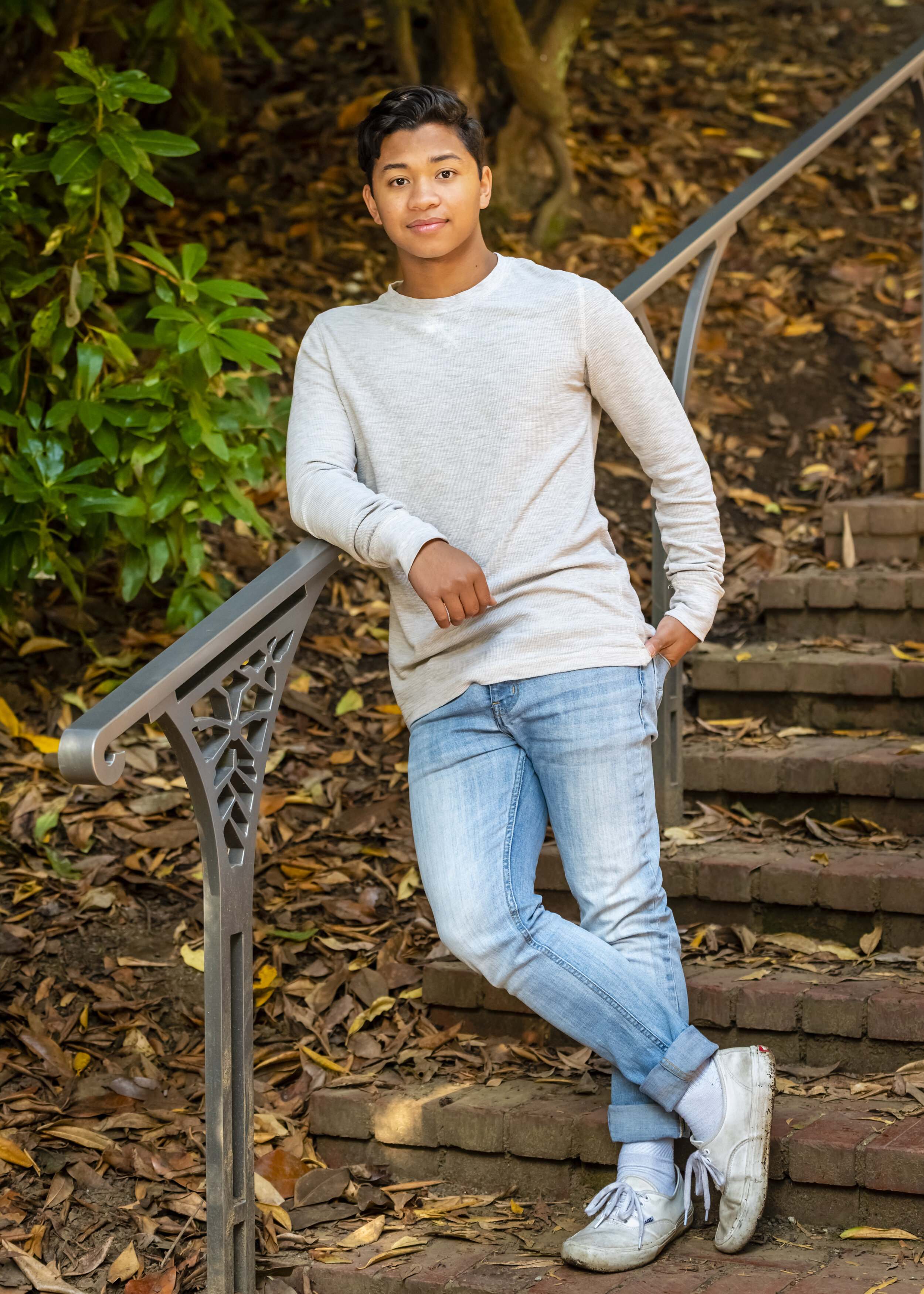 Young Man leaning against a railing