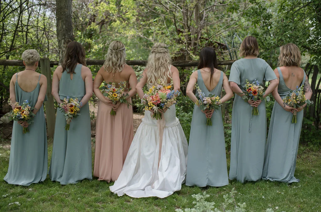  The bride and her beauties hold their gorgeous flower arrangements   