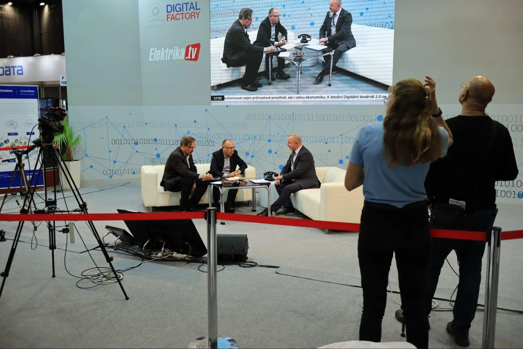 A group of men discussing and being broadcasted