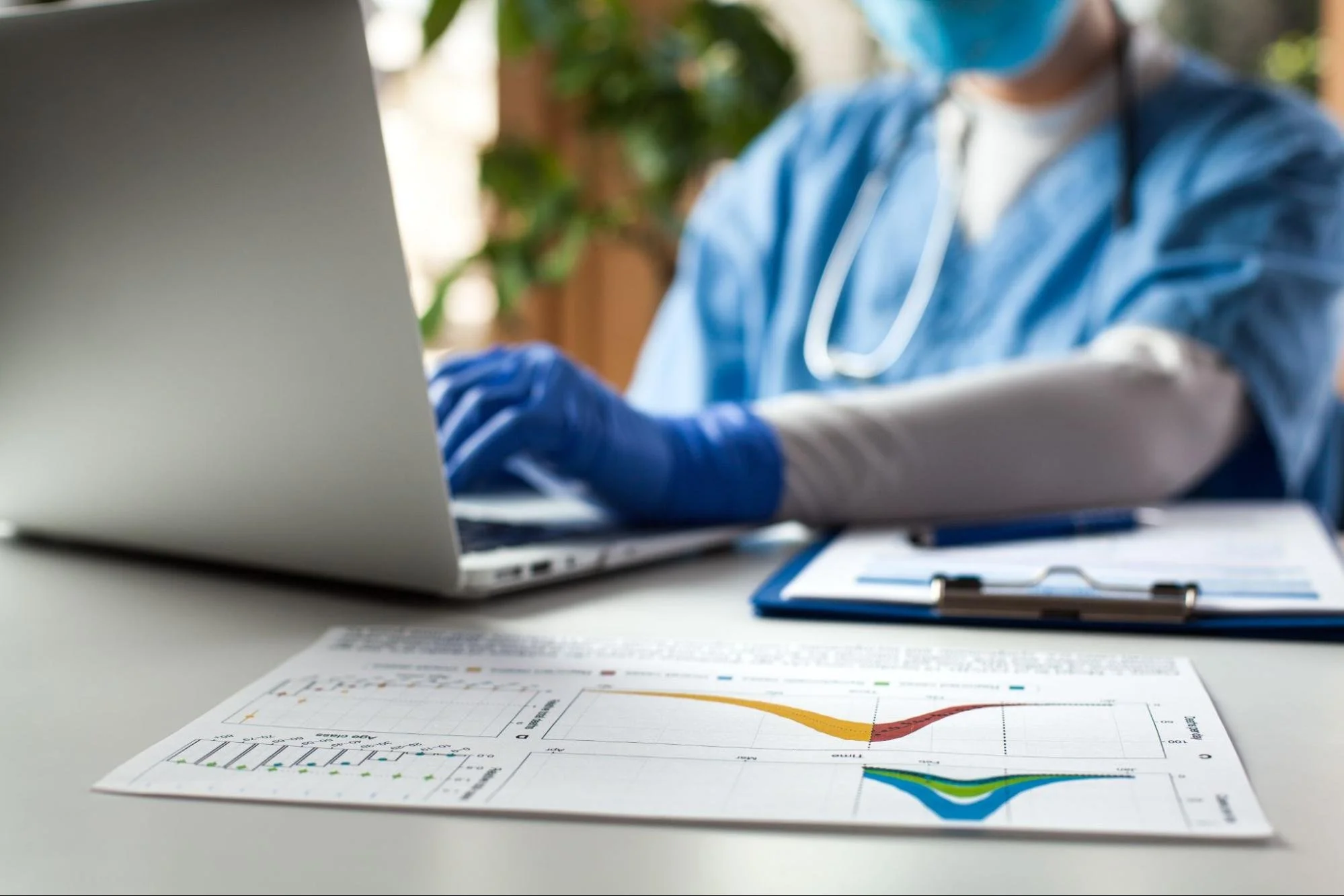 A healthcare worker working on a laptop