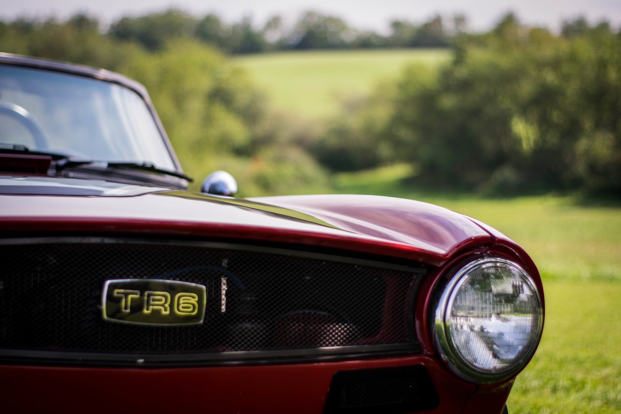  The grille is another one off piece as well. Fabricated from scratch, it holds the factory TR6 emblem, while again, providing a modernized update. We also deleted the massive front turn signals to make an additional pair of air intakes, that just so