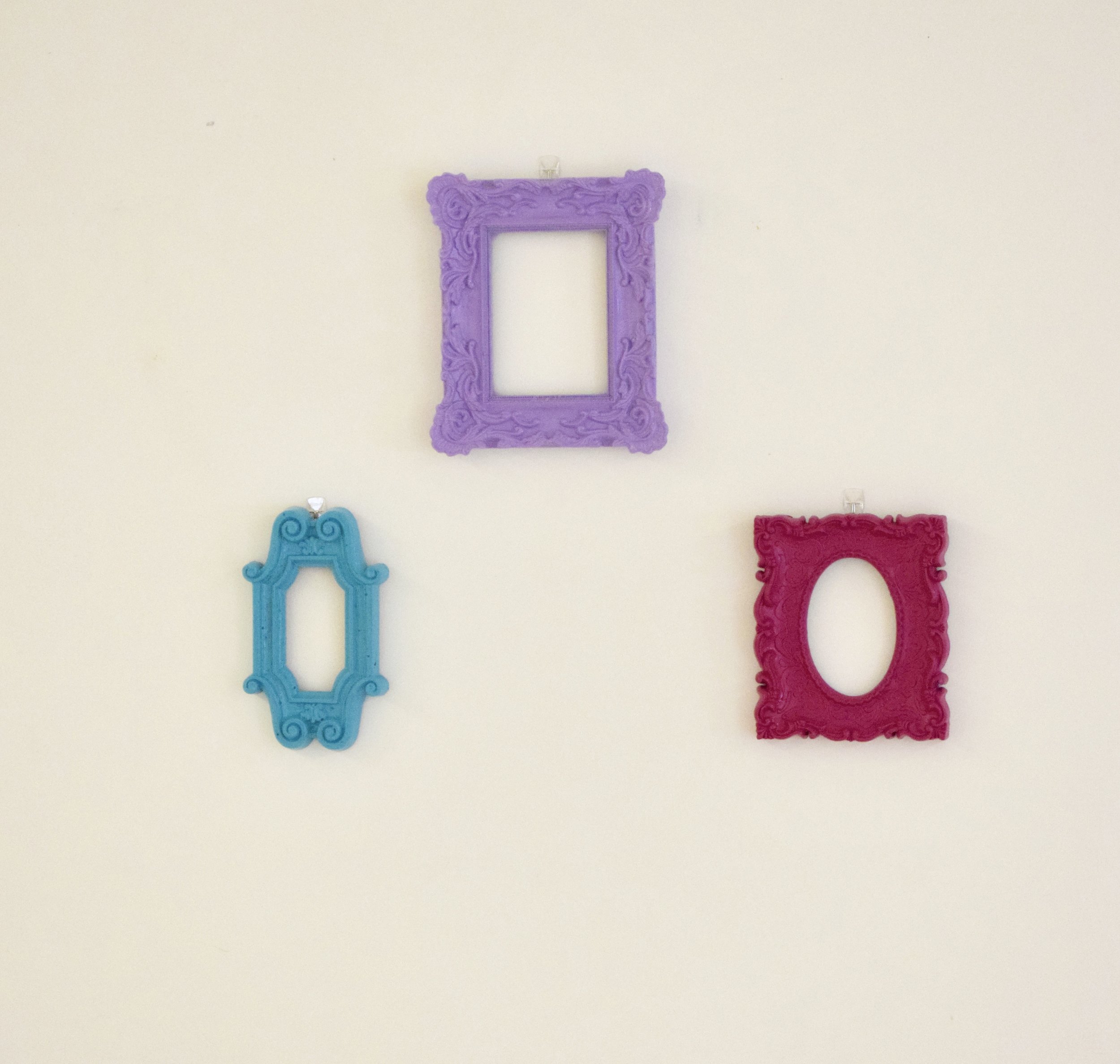 Another easy DIY is painting bright picture frames. Look for lightweight, decorative frames and paint to match your color scheme. We chose three main colors and used Command strips so that we could put them where we wanted and also remove them easily afterward.