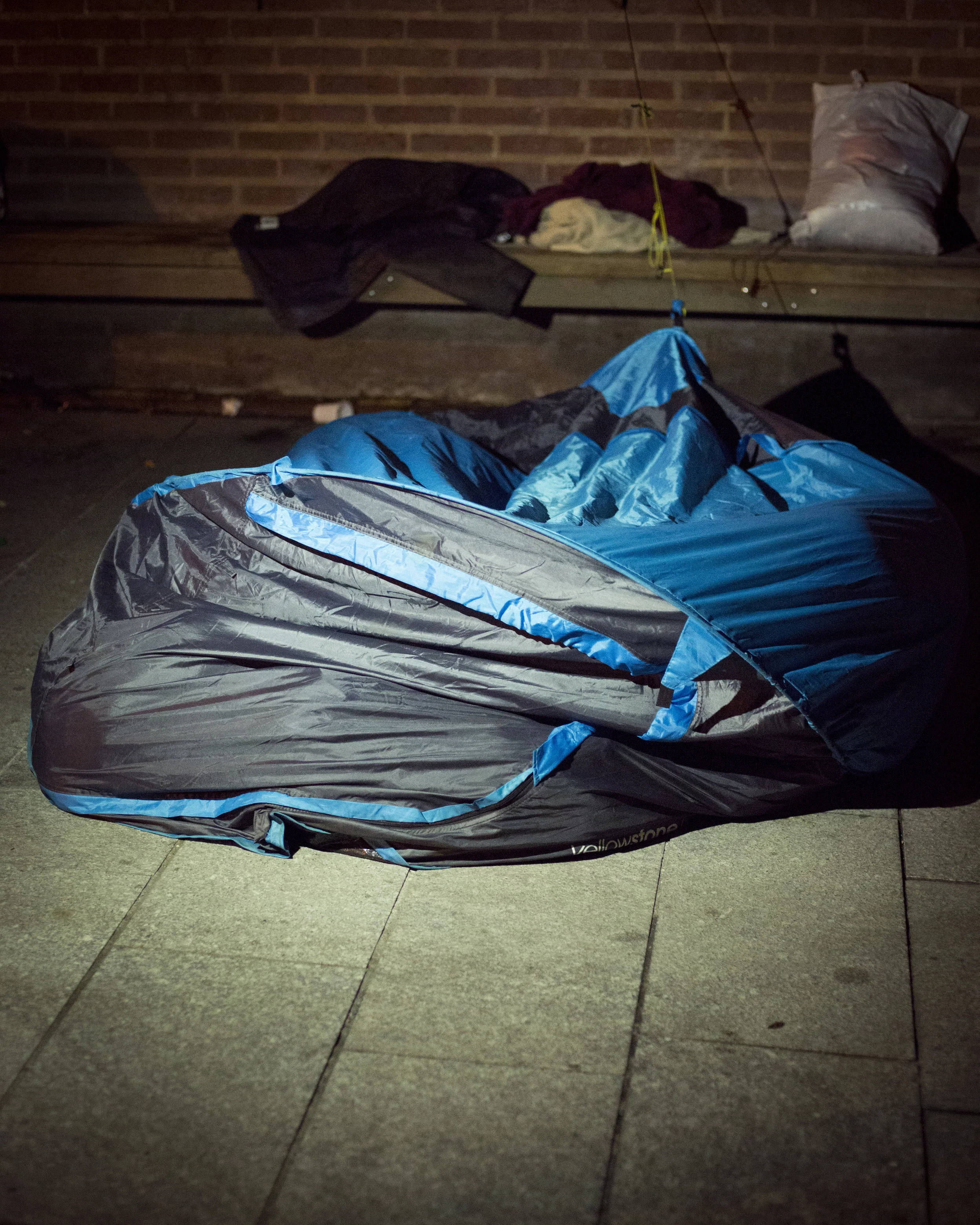 Two Men Sleeping in a Crushed Tent, St. Denis, France || For The New York Times