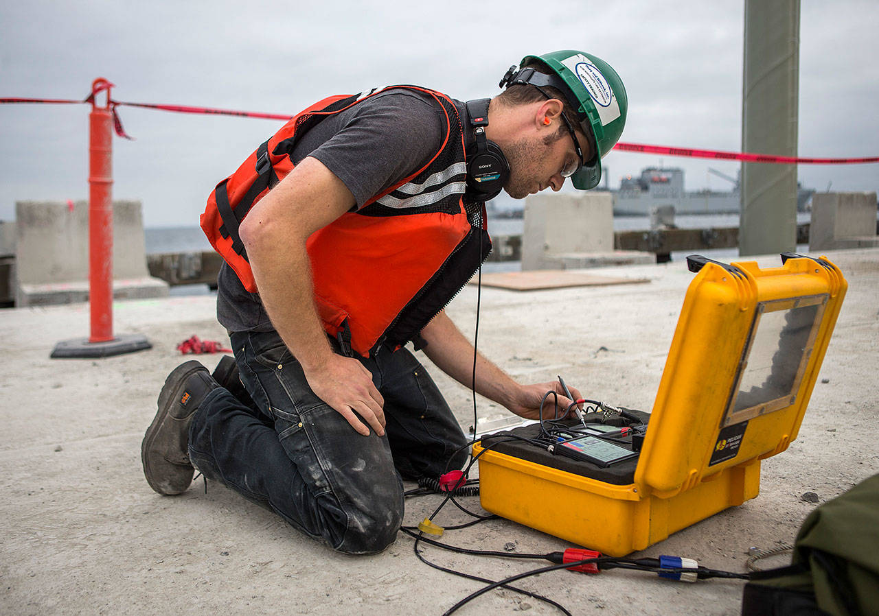 Acoustical engineer Justin Morgan writes down sound measurements during construction at the Port of Everett. (Olivia Vanni / The Herald)
