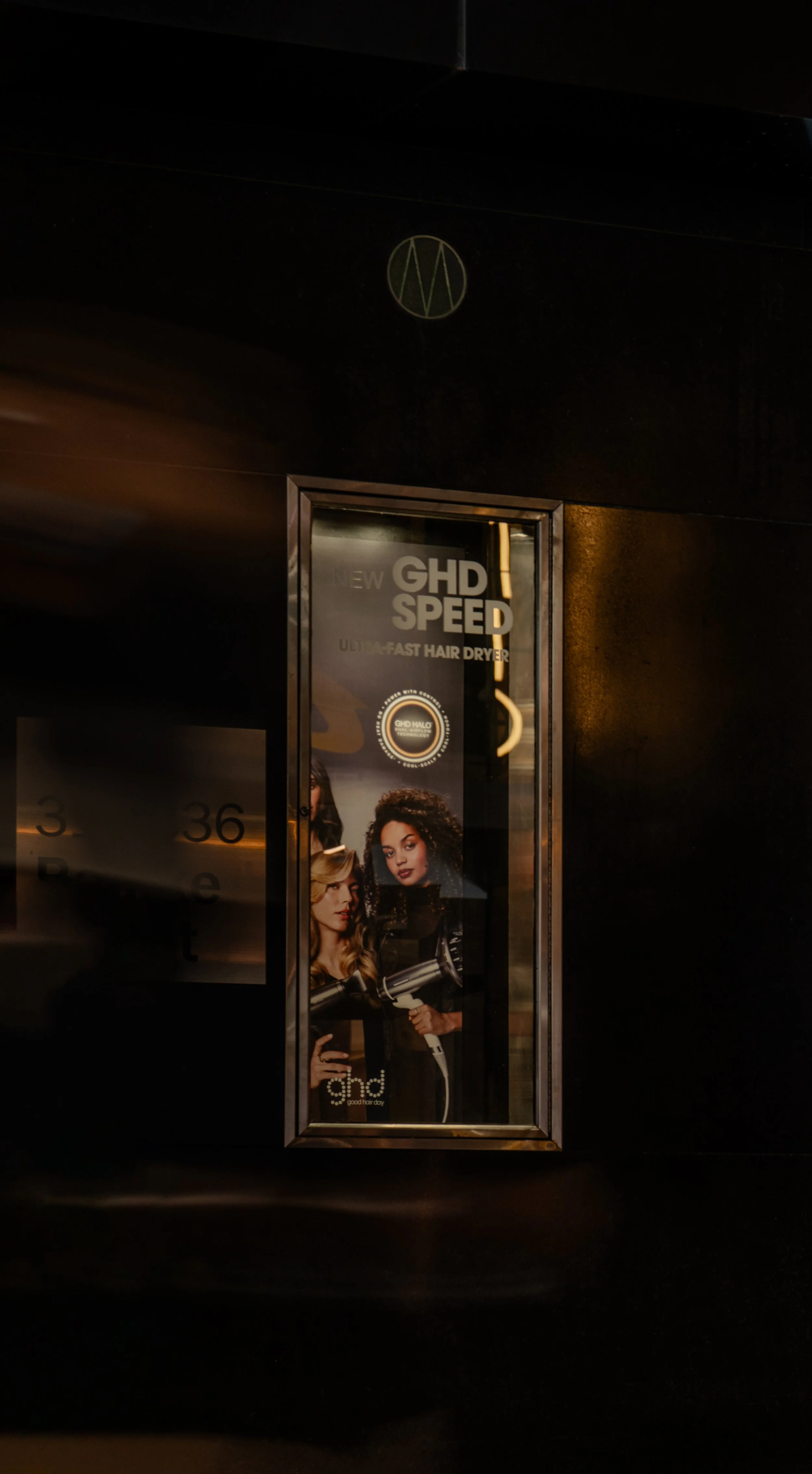Advertisement poster for GHD Speed, an ultra-fast hair dryer, showing two women with styled hair holding hair dryers.