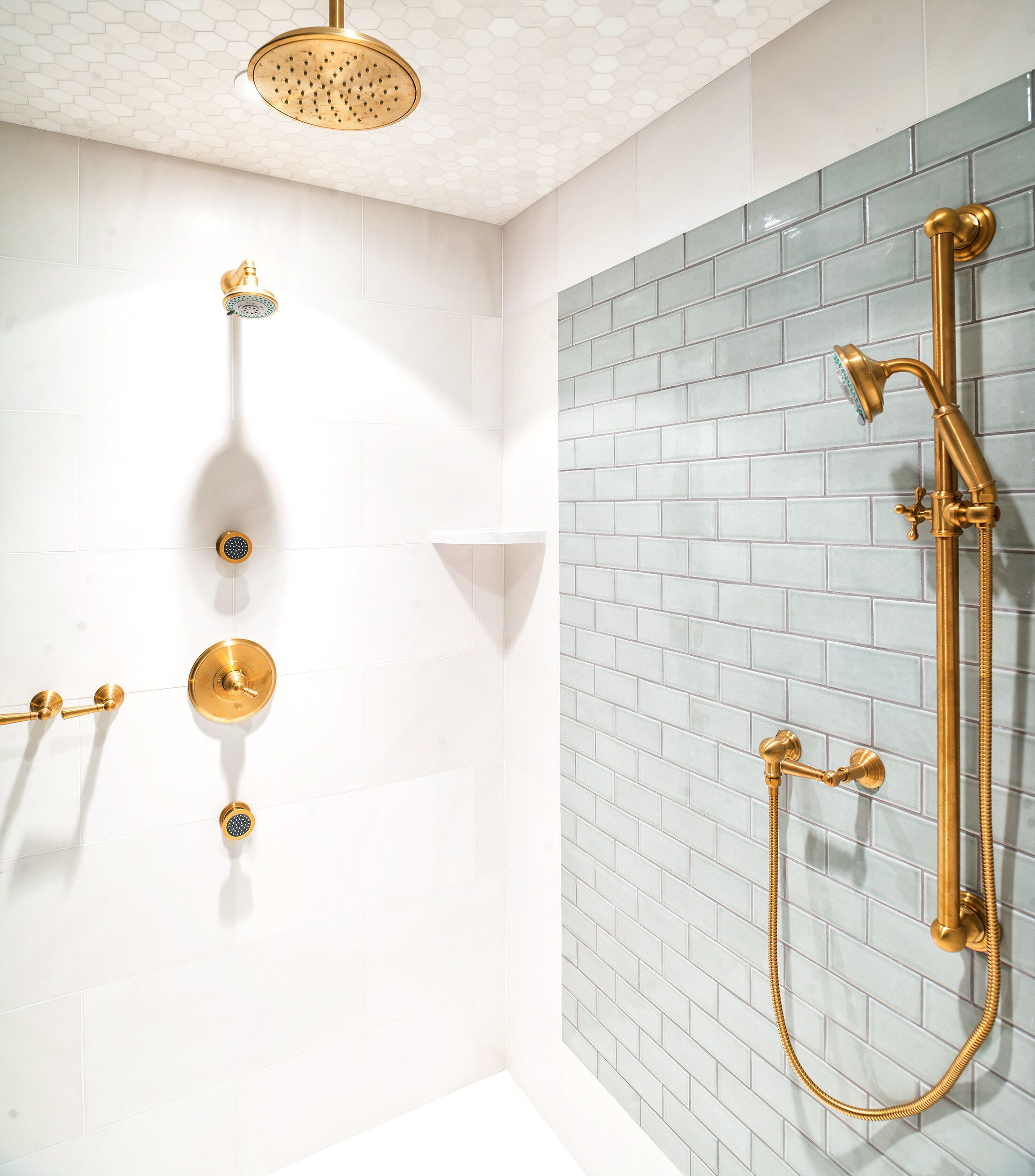Grey and white tile bathroom with gold fixtures