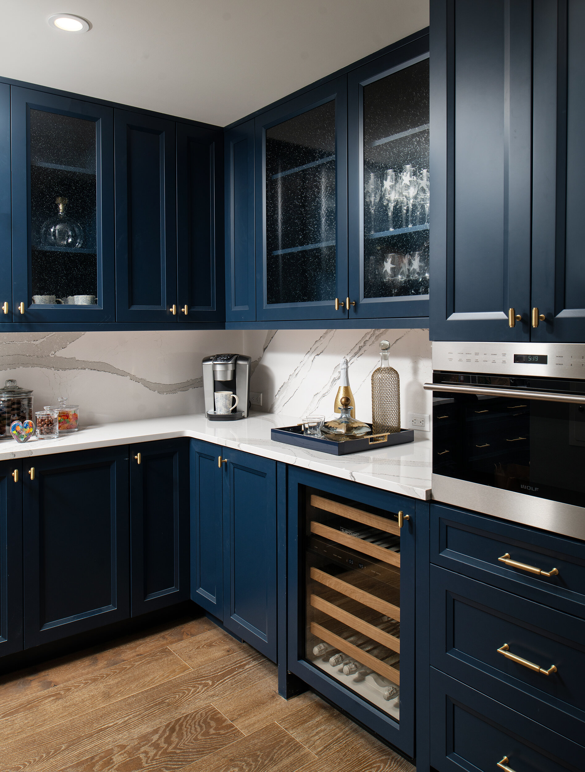 Dark blue cabinets with white marble endless backsplash