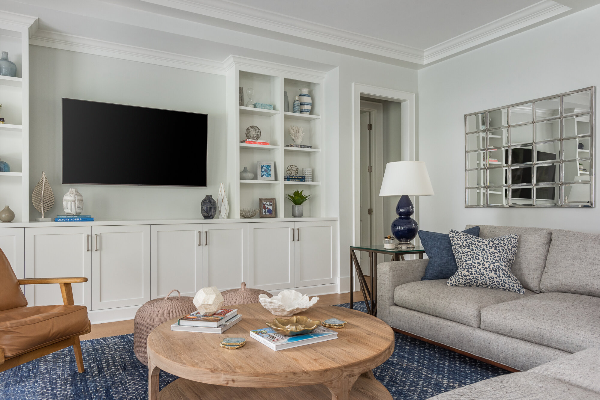 White built in tv console wood, grey, and blue accents