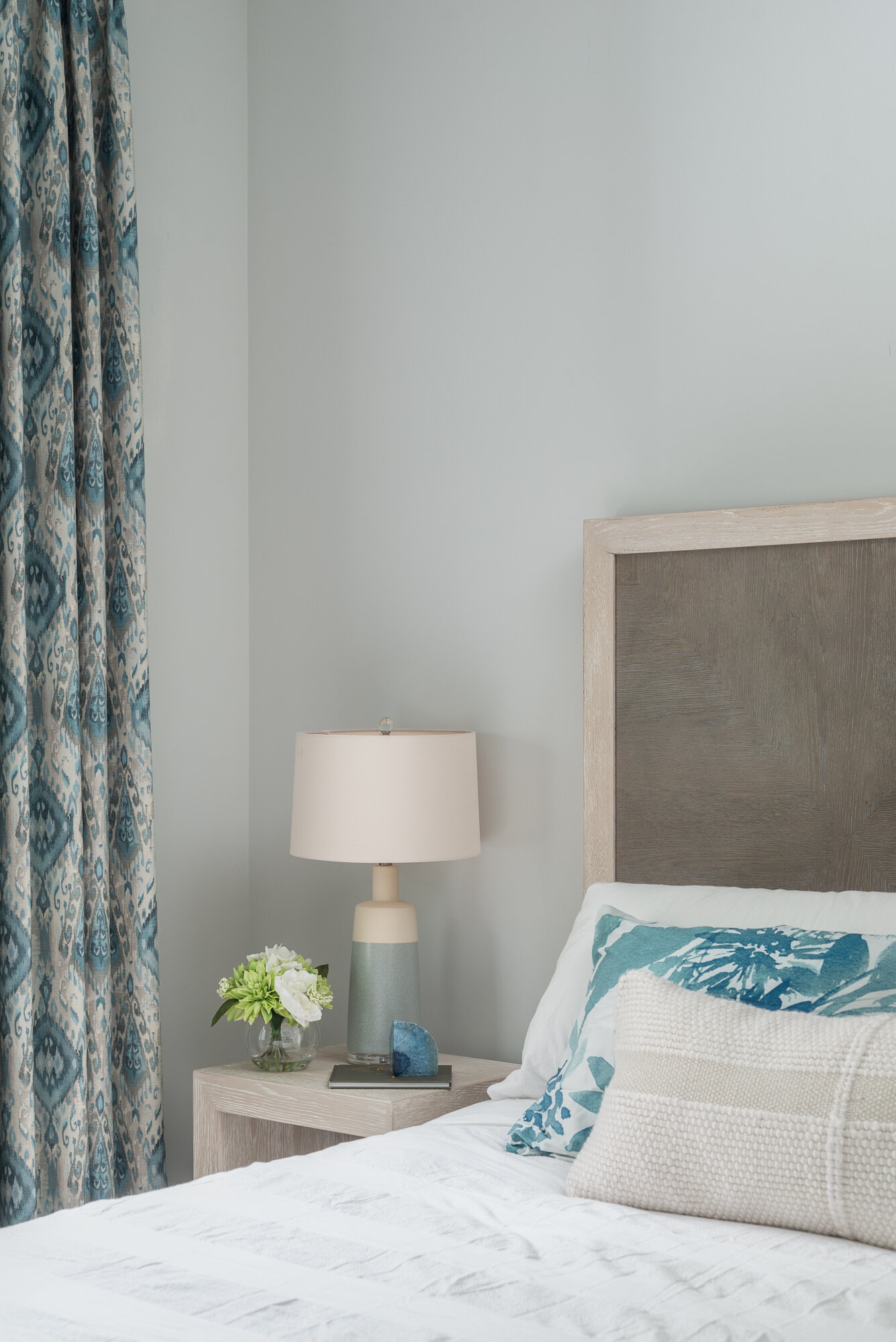 Bedroom light blue and grey with blue pattern curtains