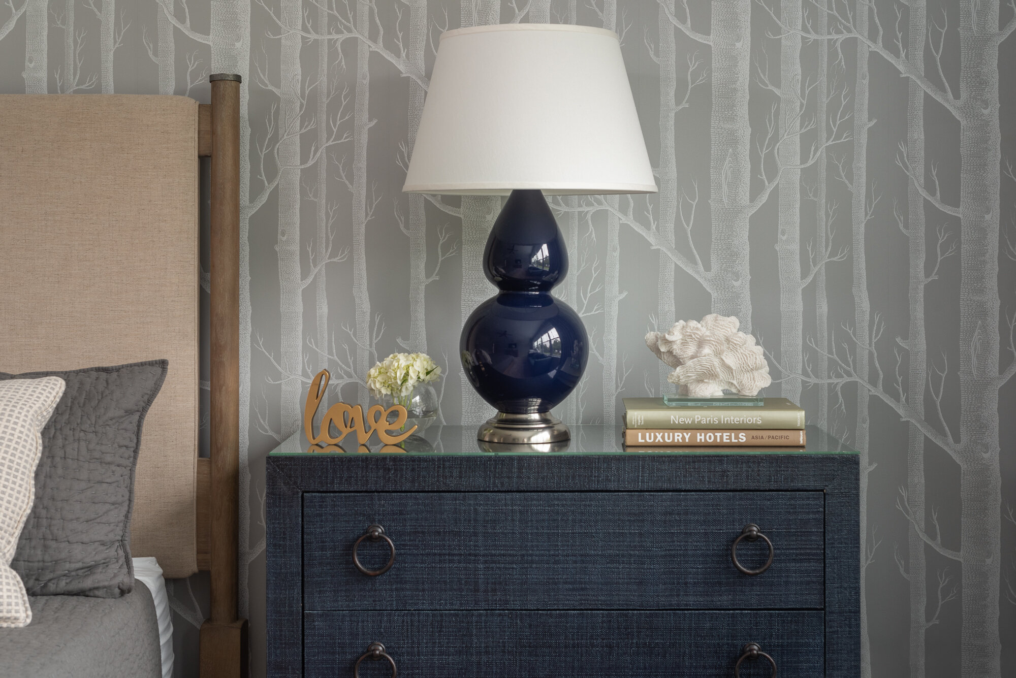 Dark blue night stand with blue lamp and white lamp shade