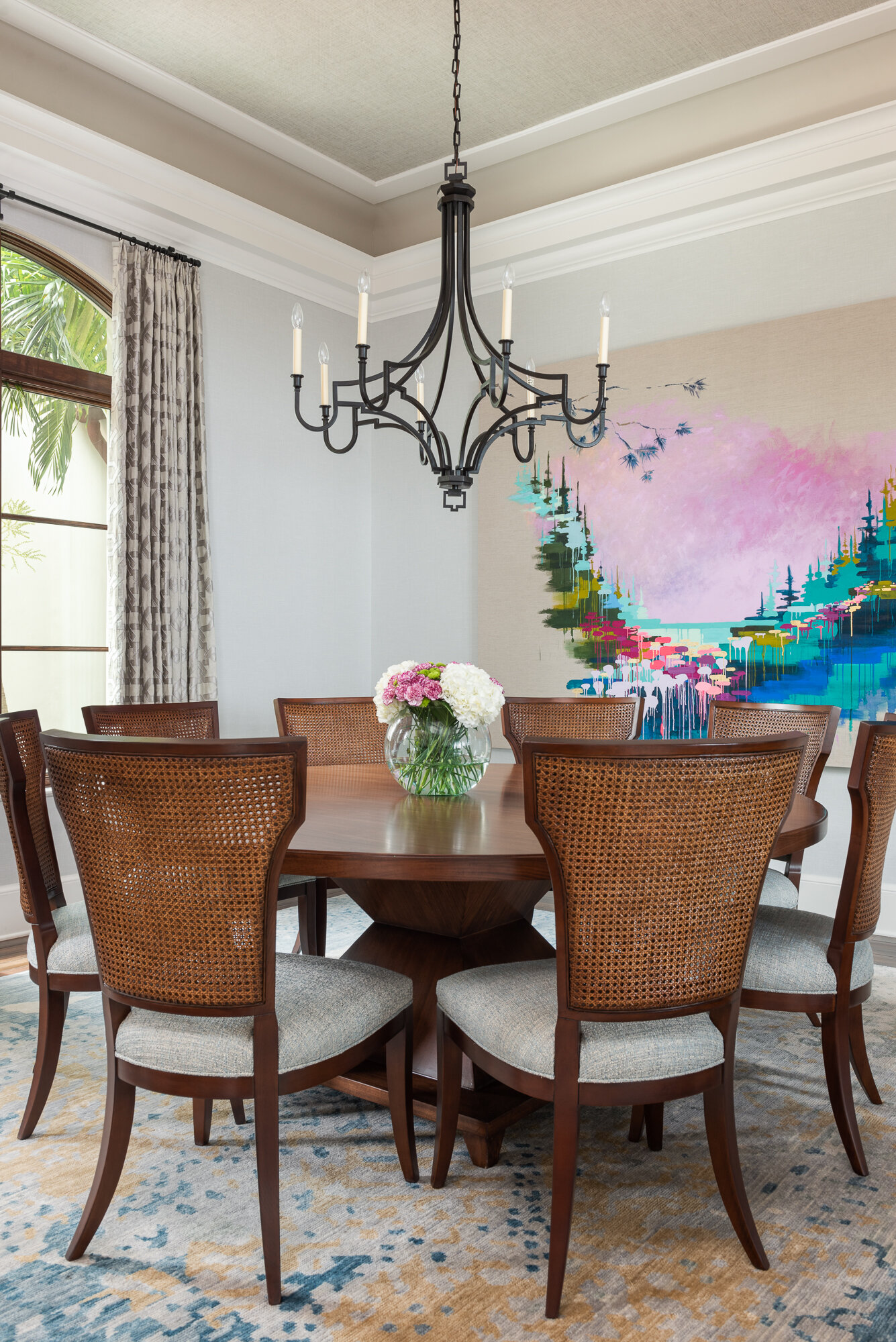 Dining room simple black chandelier colorful art and wood dining table