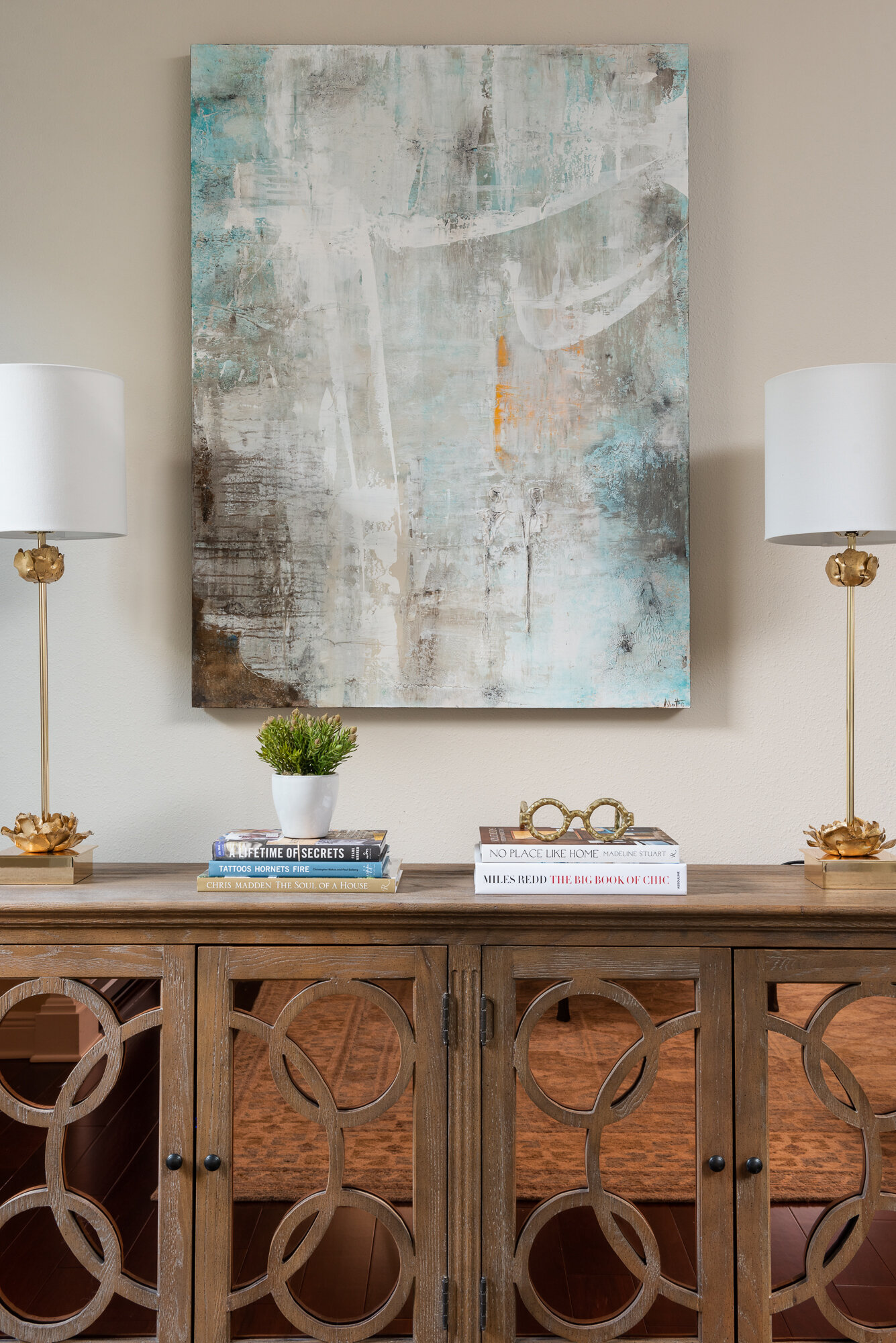 Living room sideboard with lamps and neutral painting