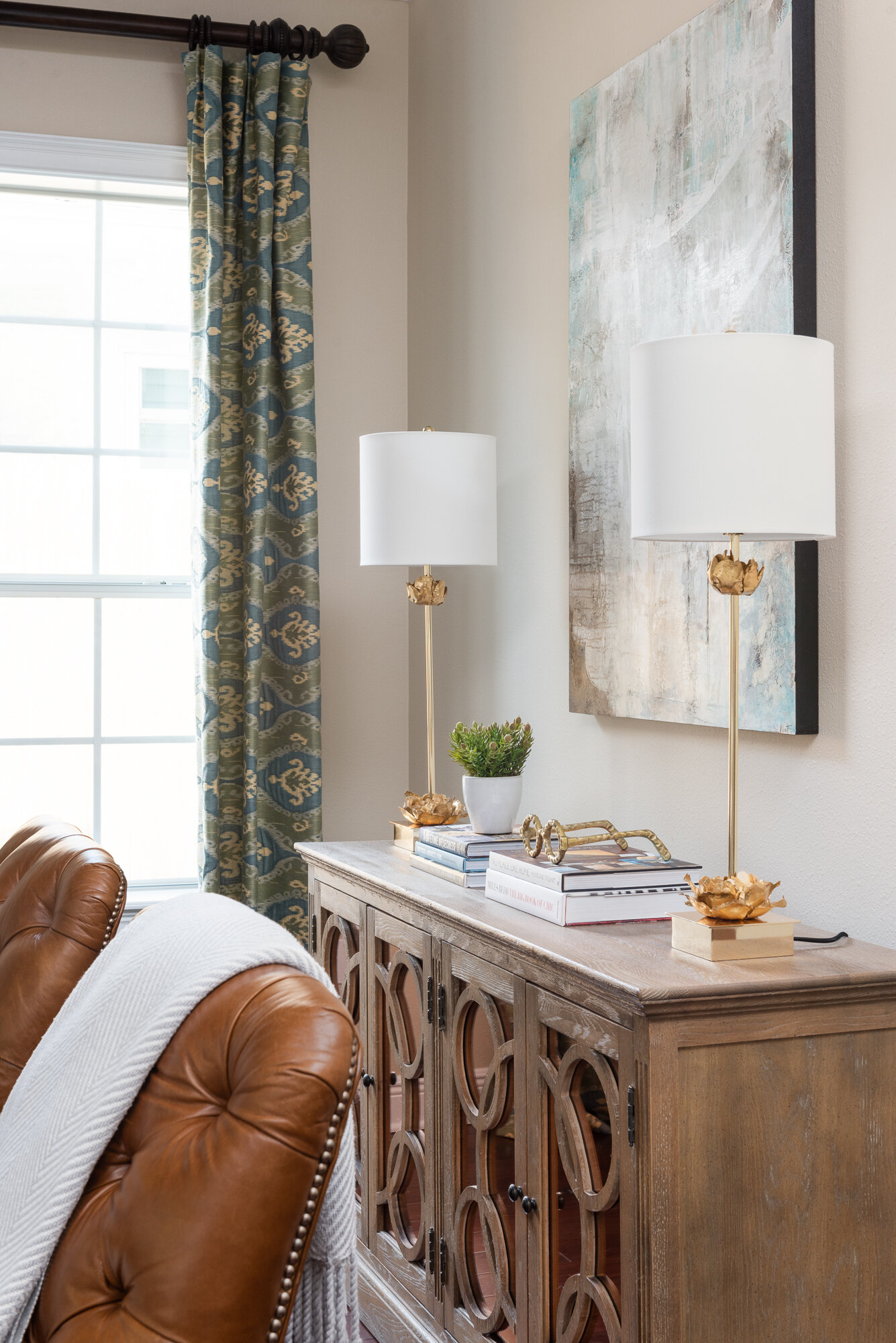 Living room sideboard with lamps and neutral painting