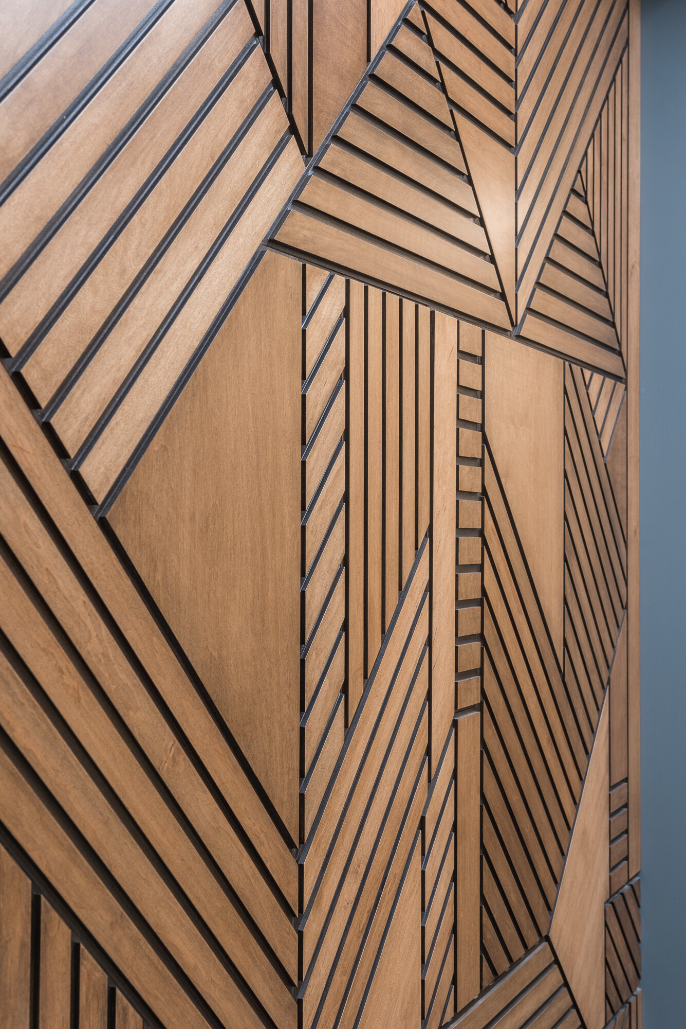 Wood geometric accent wall lobby