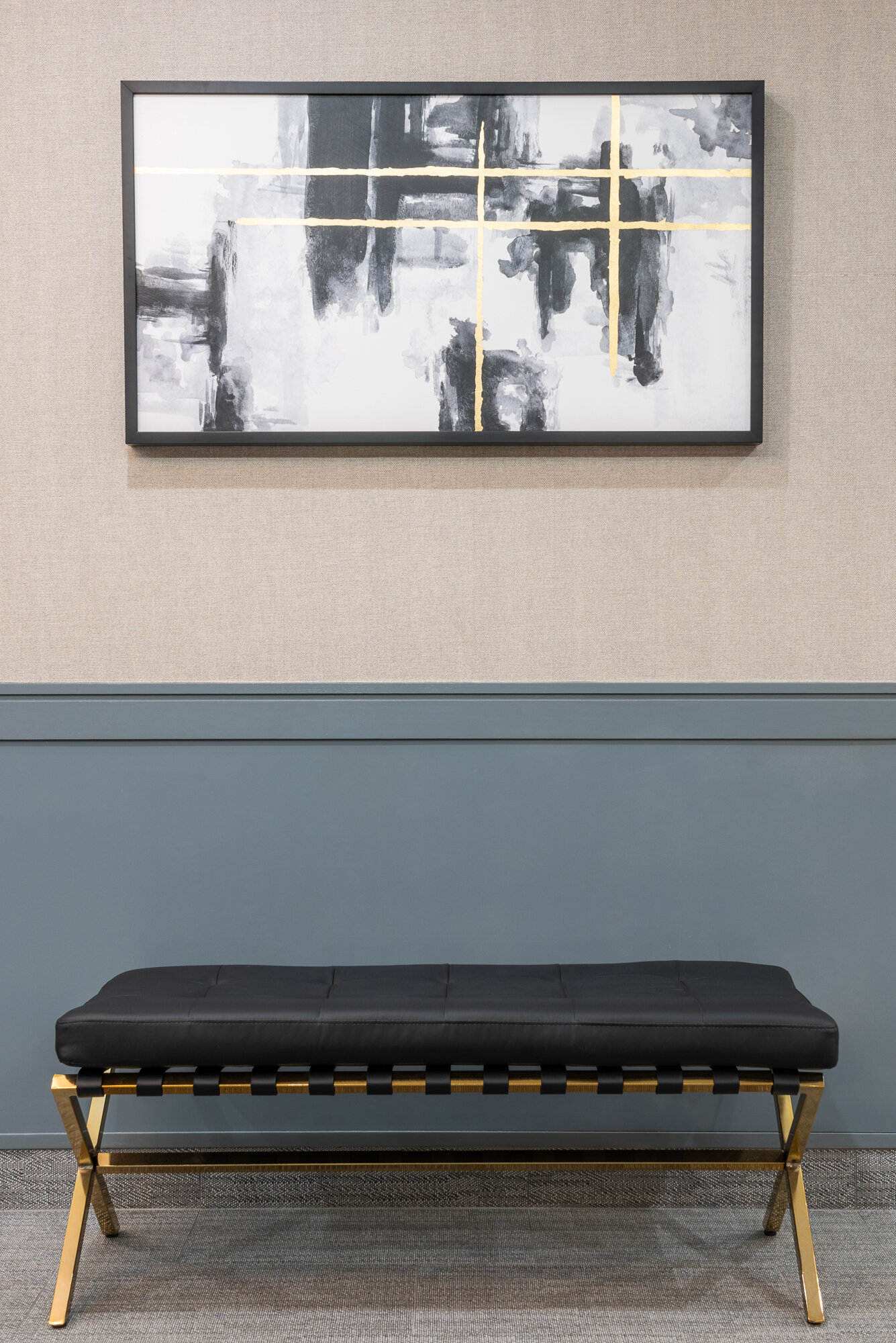 black leather bench and gold features with black white and gold painting