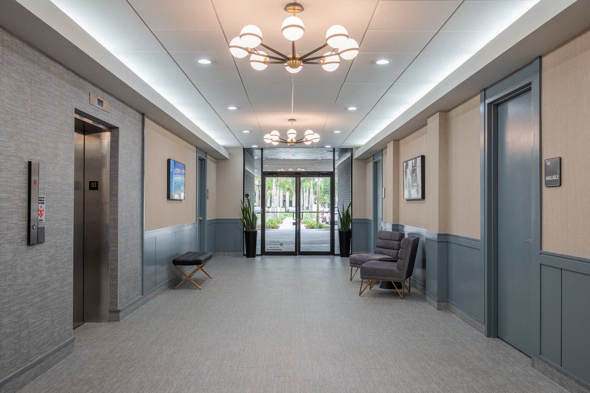 Office lobby grey and muted teal with ball chandelier