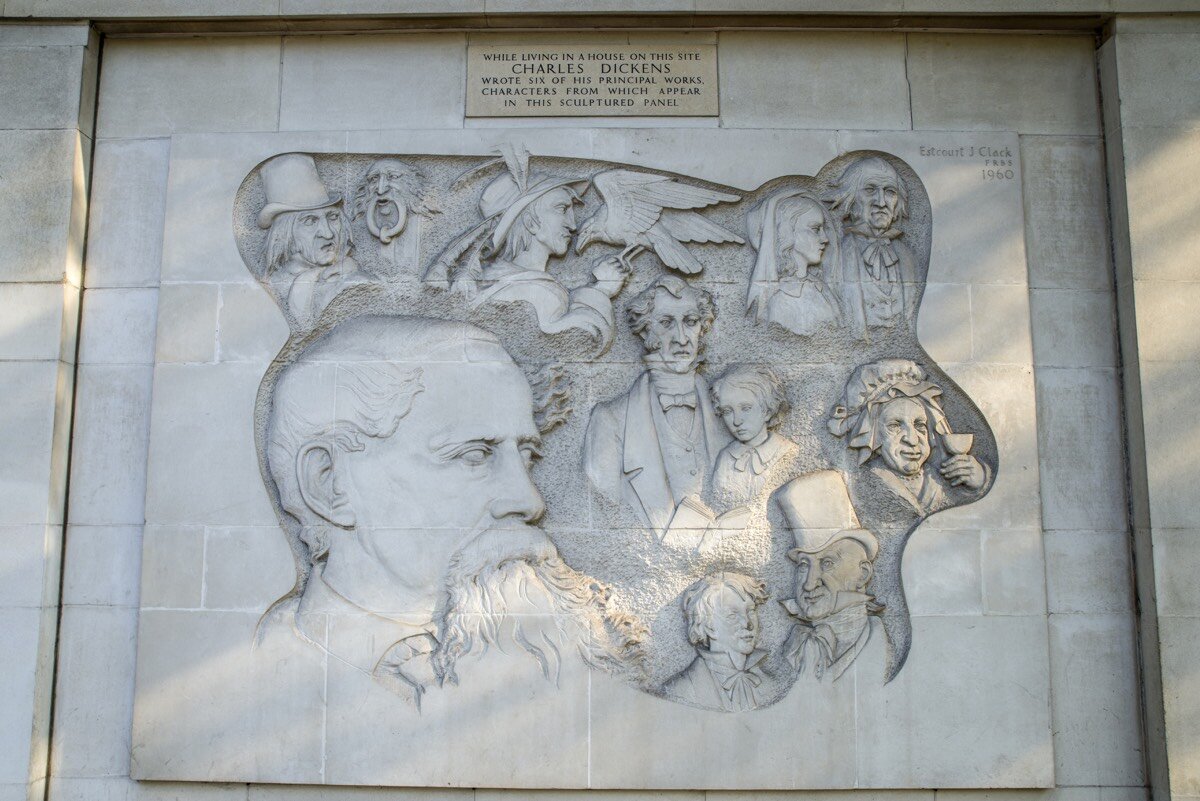A London mural of Charles Dickens, surrounded by his fictional characters. Directly above Dickens’s head, there is a depiction of Scrooge and his famed door-knocker.