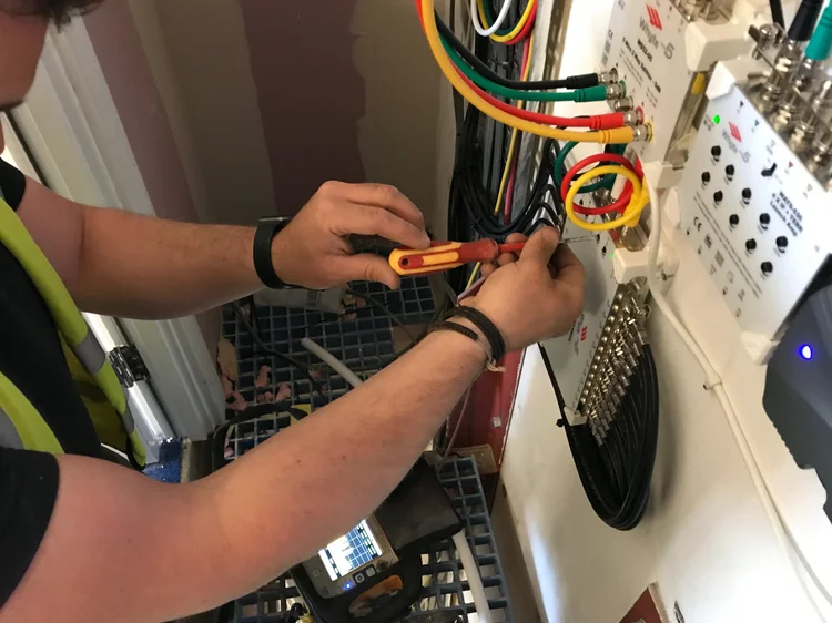 A Nerds2u engineer wiring a smart-home patch panel
