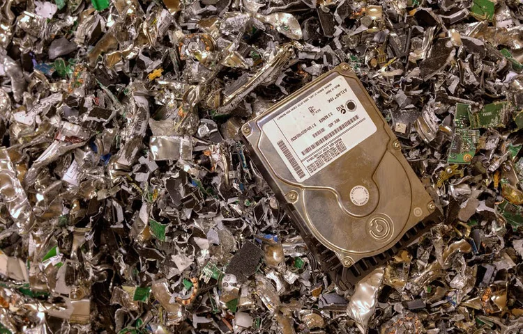 A destroyed hard drive on shredded metal