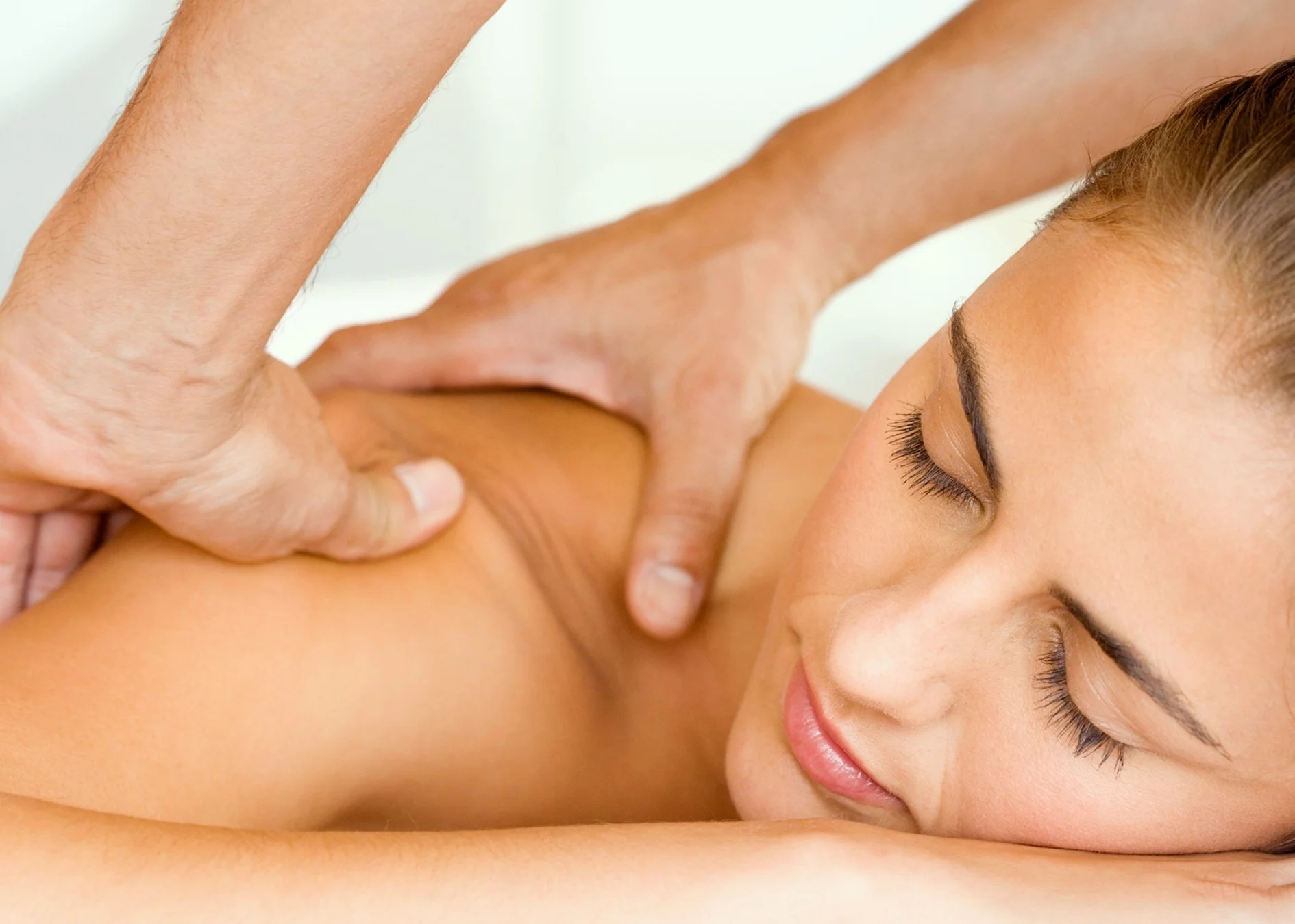 Woman receiving a relaxing shoulder massage to ease muscle tension.