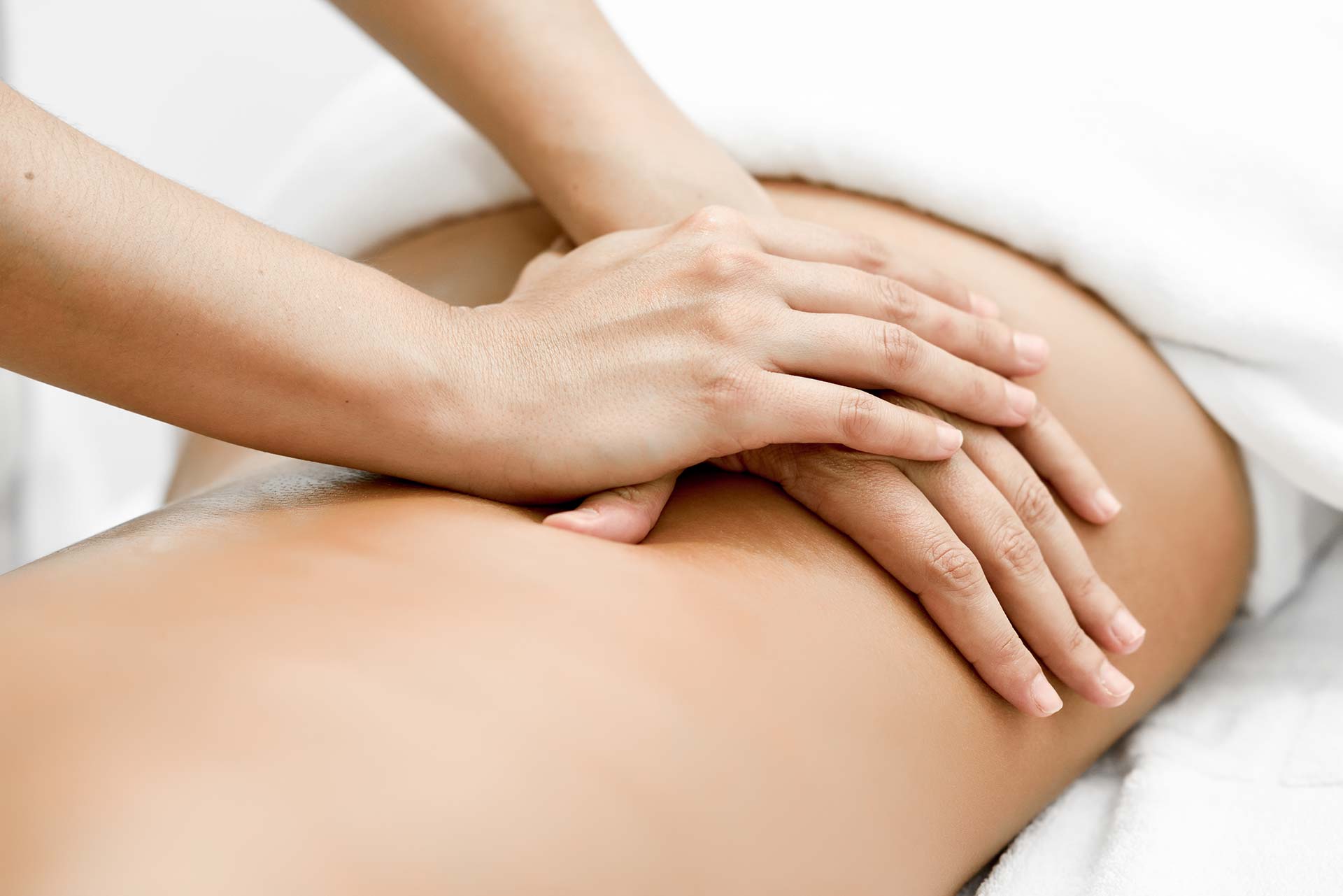 Hands performing a therapeutic massage on the back to promote relaxation and relieve muscle tension.