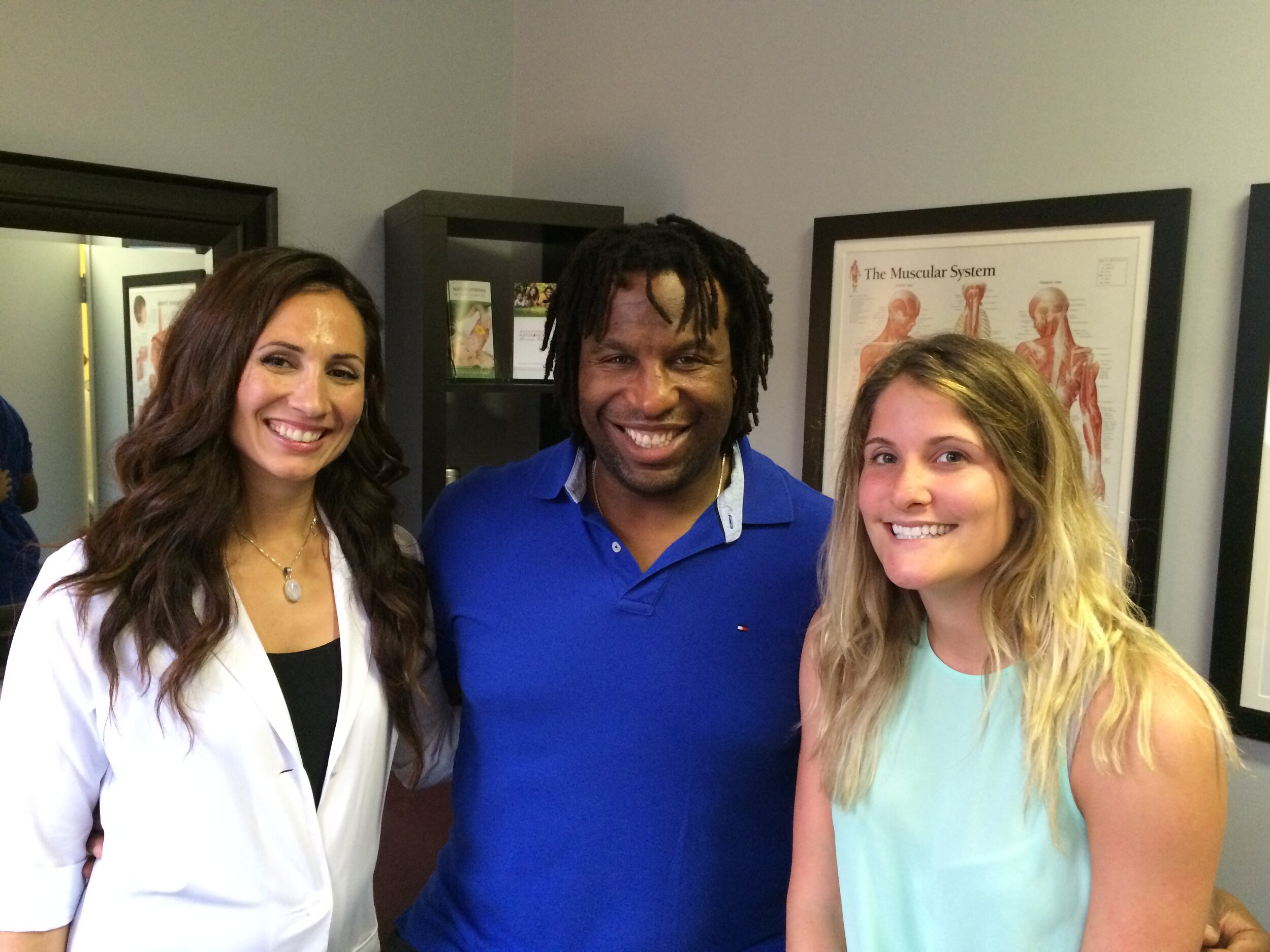 Zeina Raya with former professional hockey player Georges Laraque and another person at an event in Montreal.