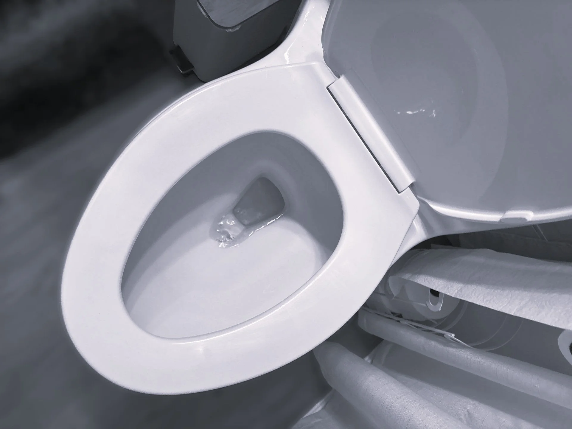 Top view of a white front-loading washing machine with its door open, showing the drum.