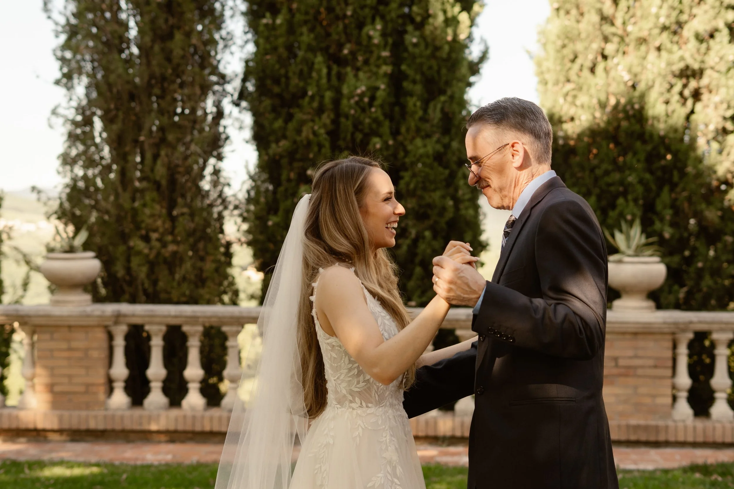 the bride and her father dancing together for their father-daughter dance songs