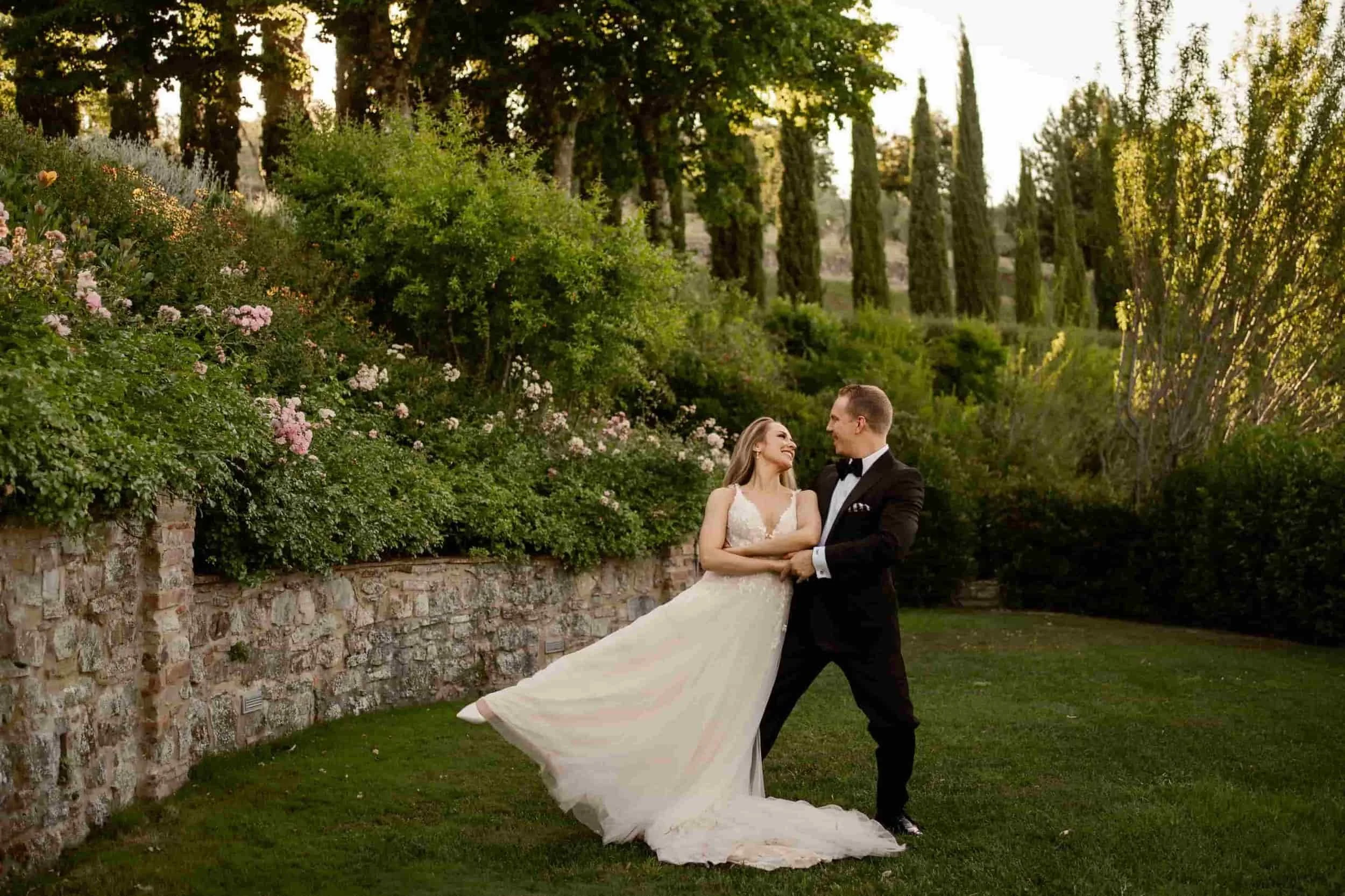 a bride and groom dancing their first dance outside. they learned how long should a wedding dance be at ballroomfeed.com