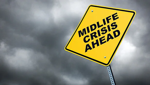 Yellow road sign saying mid life crisis
