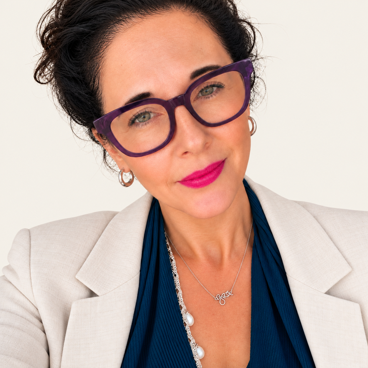 Portrait of Pauline Harley, independent consultant specialising in workplace health, wellbeing and neurodiversity, wearing purple glasses and a cream blazer.