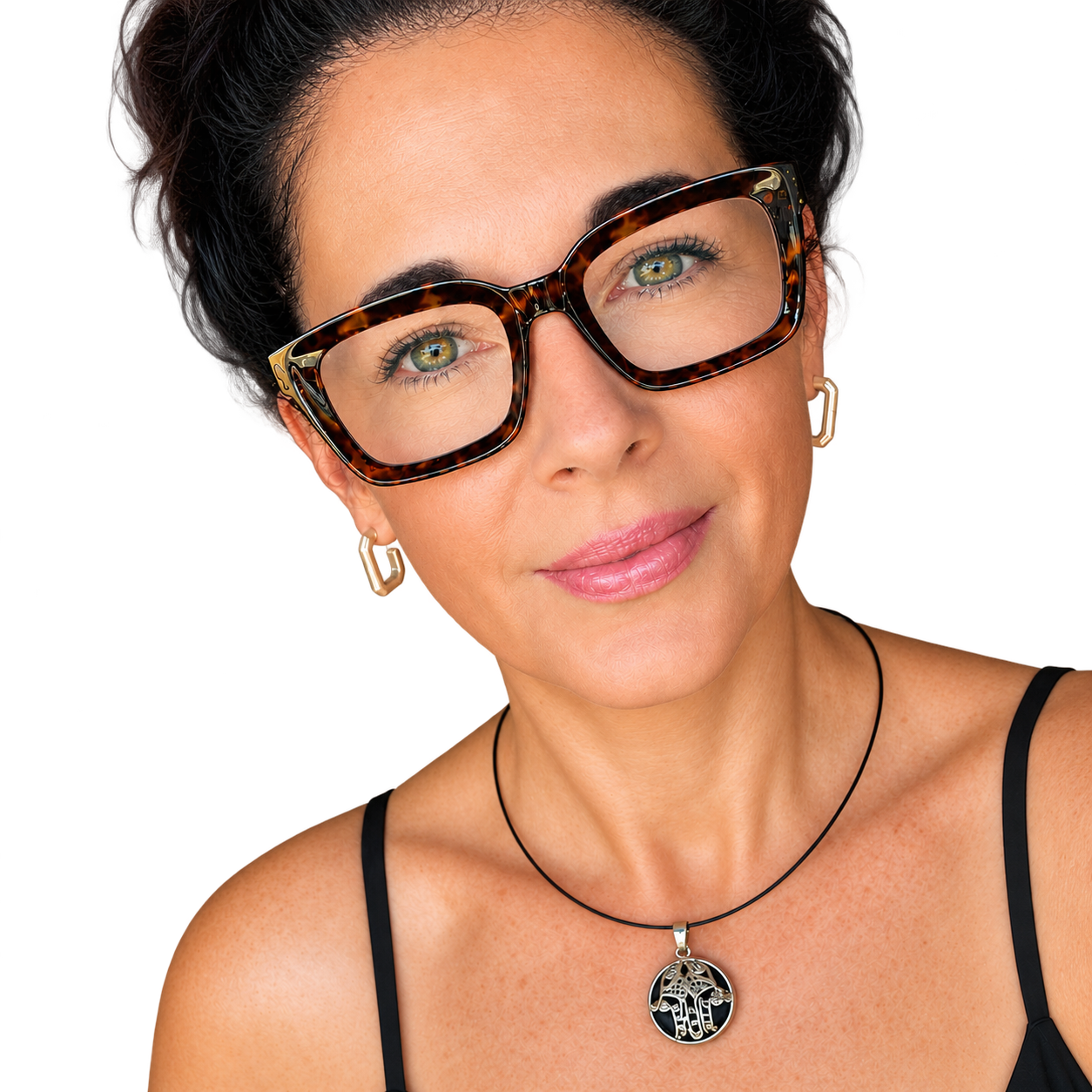Portrait of Pauline Harley, founder of Advocating Autonomy, wearing tortoiseshell glasses, gold earrings and a black top, with dark hair styled up against a black background.