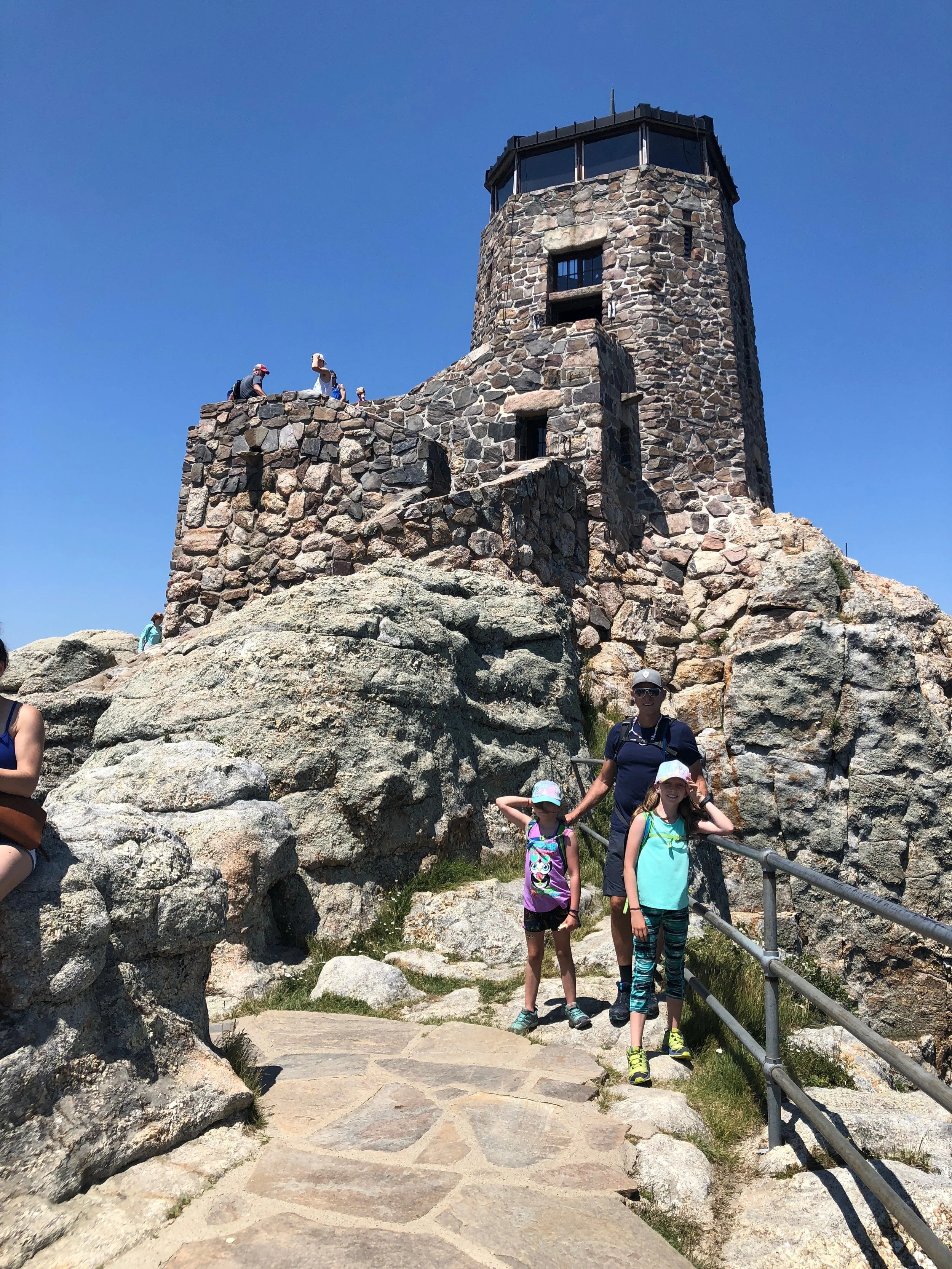 At the Top of Black Elk Peak, 7,244ft. This is an old fire tower that was pretty cool to check out. When we went up to the top level we all bent down so Isla was the tallest person in all of South Dakota for a few seconds!!!