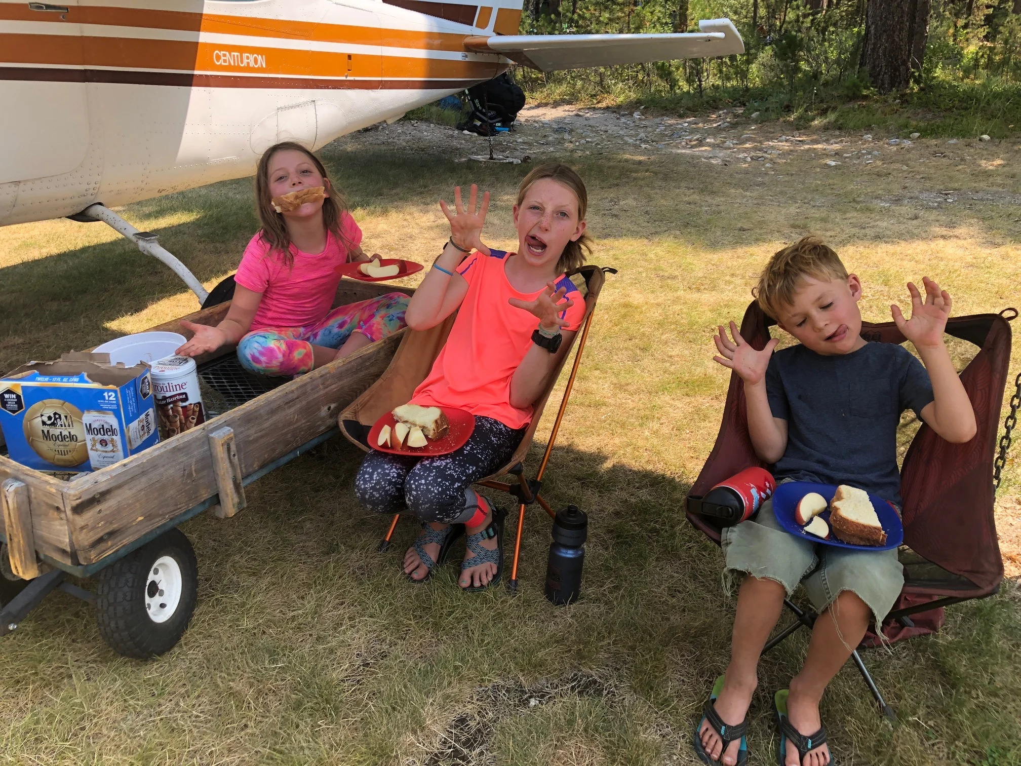 Being goofy while having lunch in the shade of the wing of the plane