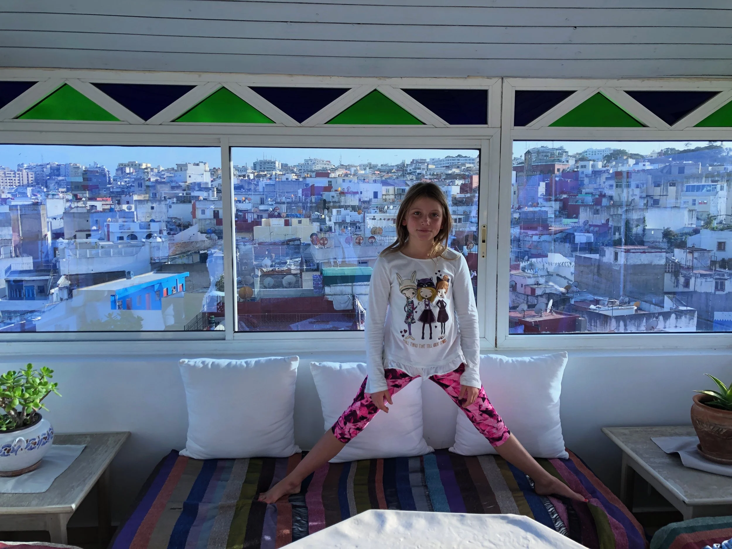 Isla on the roof of our riad with the medina in Tangier behind her