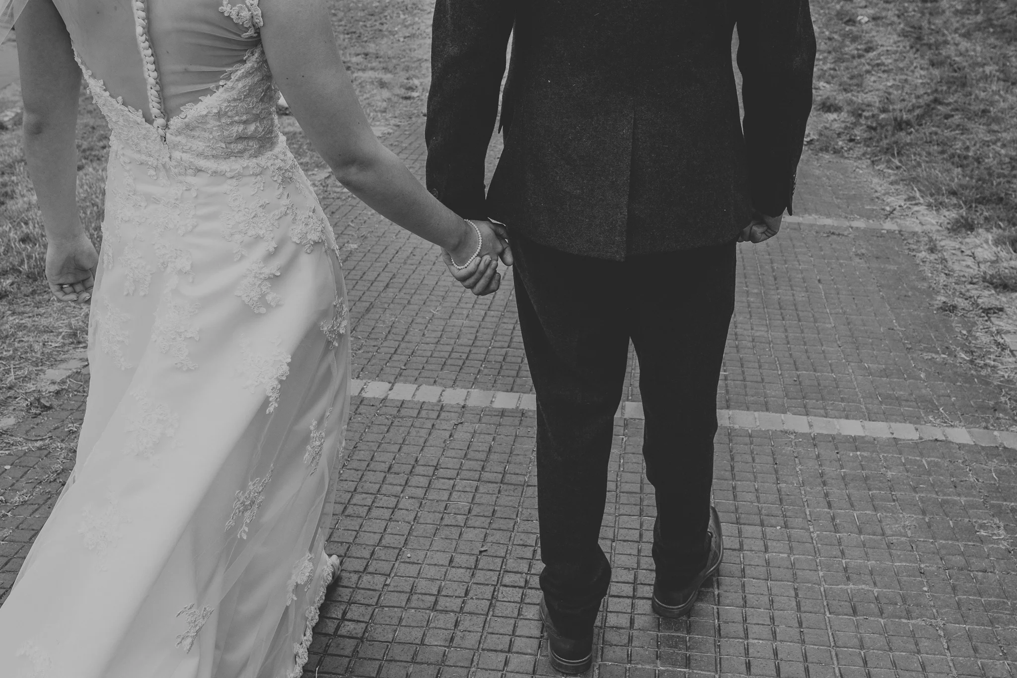 Jess and Ben - Liverpool wedding - black and white, bride and groom holding hands
